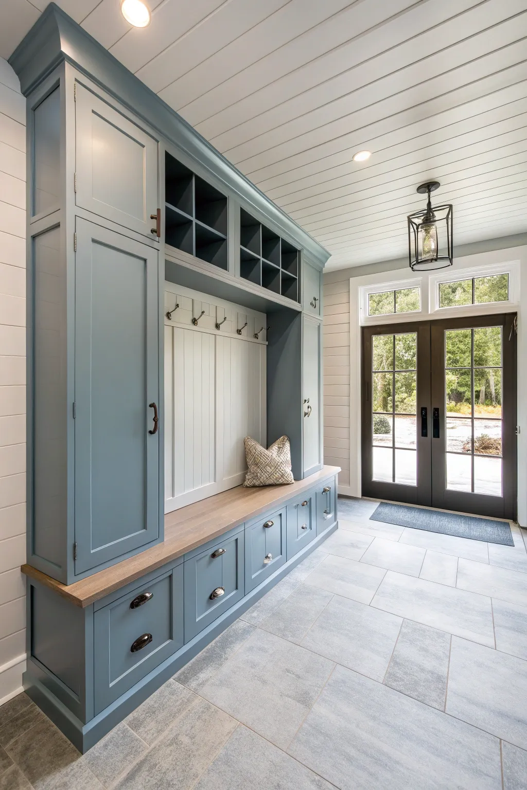 A modern mudroom with cool toned wood accents and sleek cabinetry.