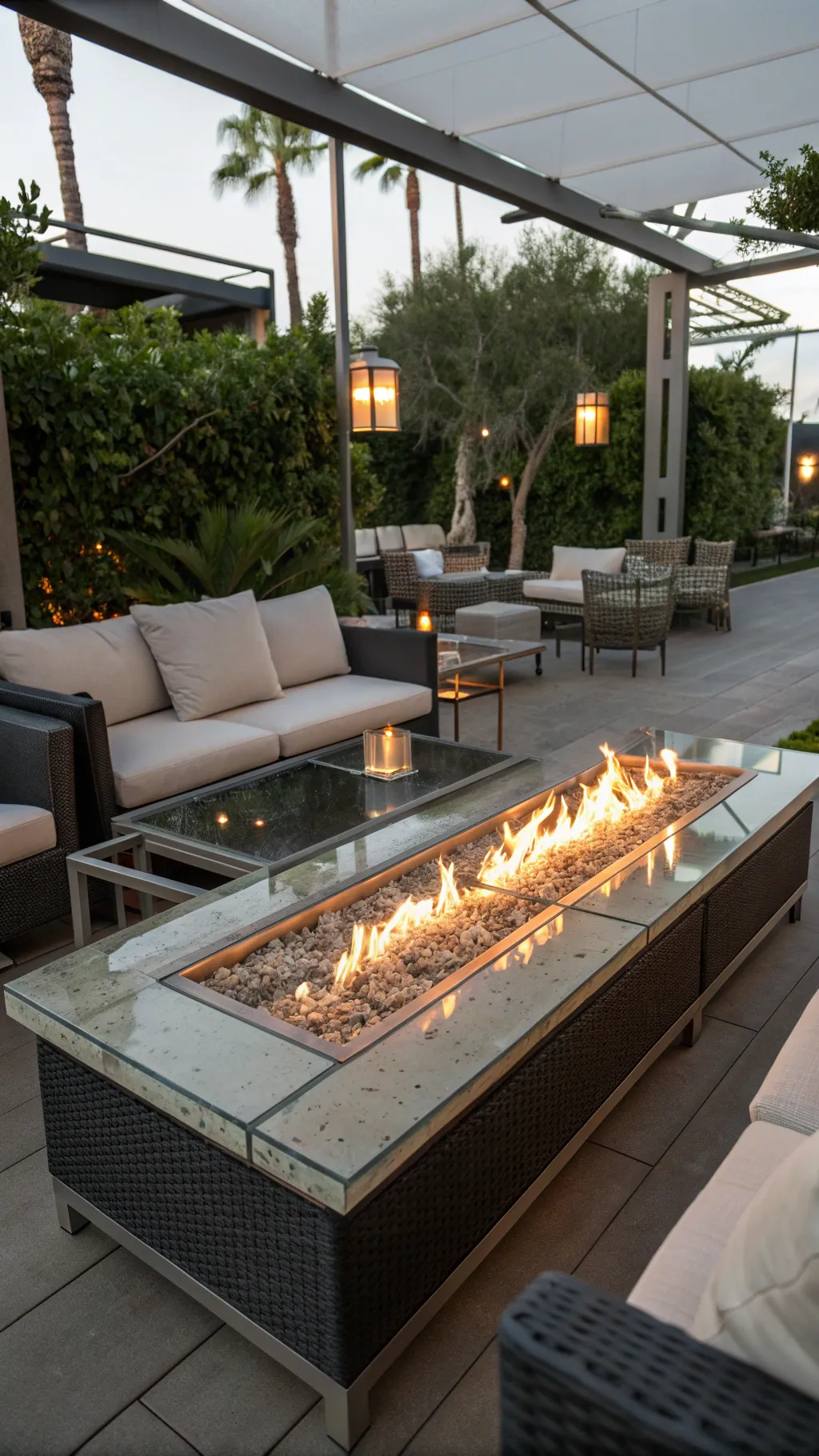A contemporary glass fire pit table in a modern outdoor lounge setting.