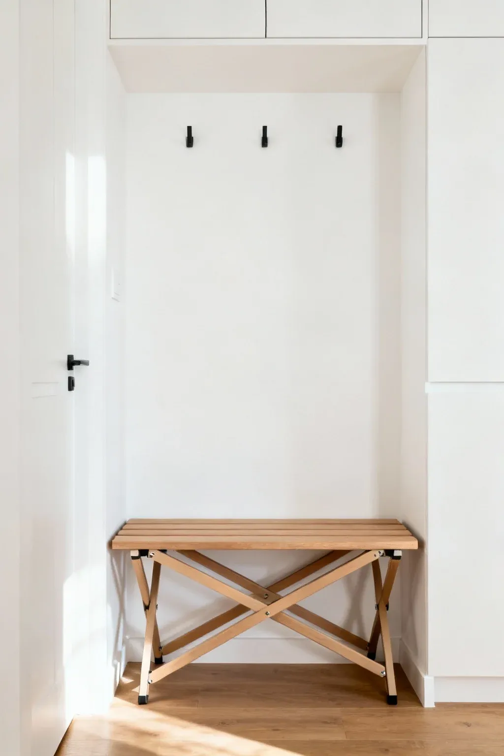Foldable furniture in a compact and functional tiny mudroom.