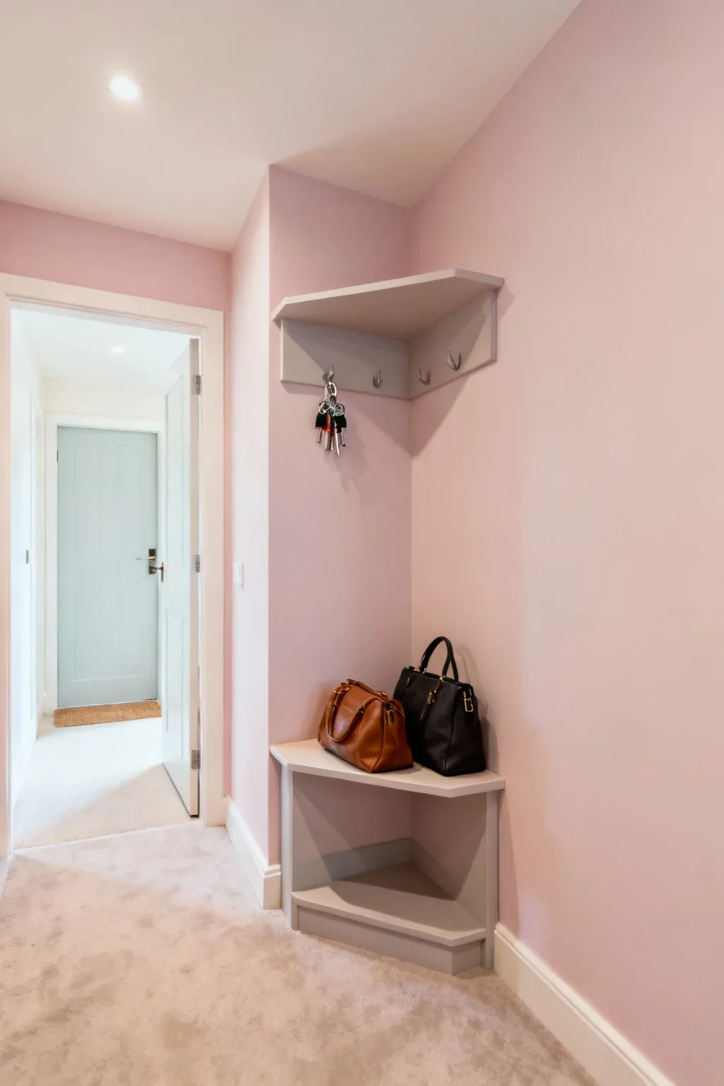 Compact corner shelf in a tiny mudroom for organizing essentials.