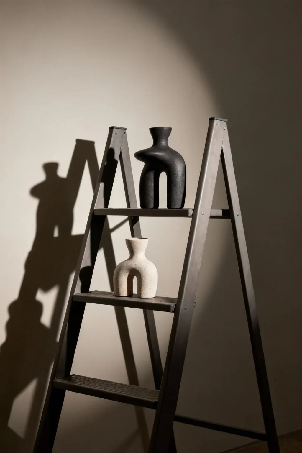 A ladder shelf decorated with unique sculptures enhancing the decor.