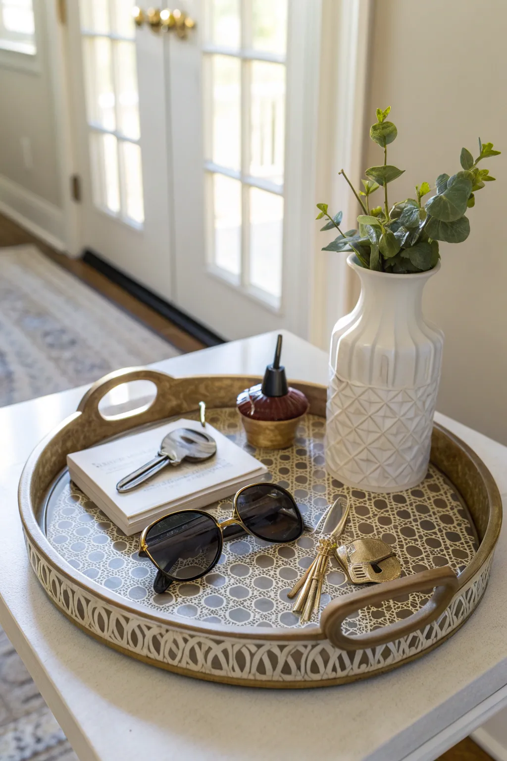 A decorative tray organizing items on an entry table.
