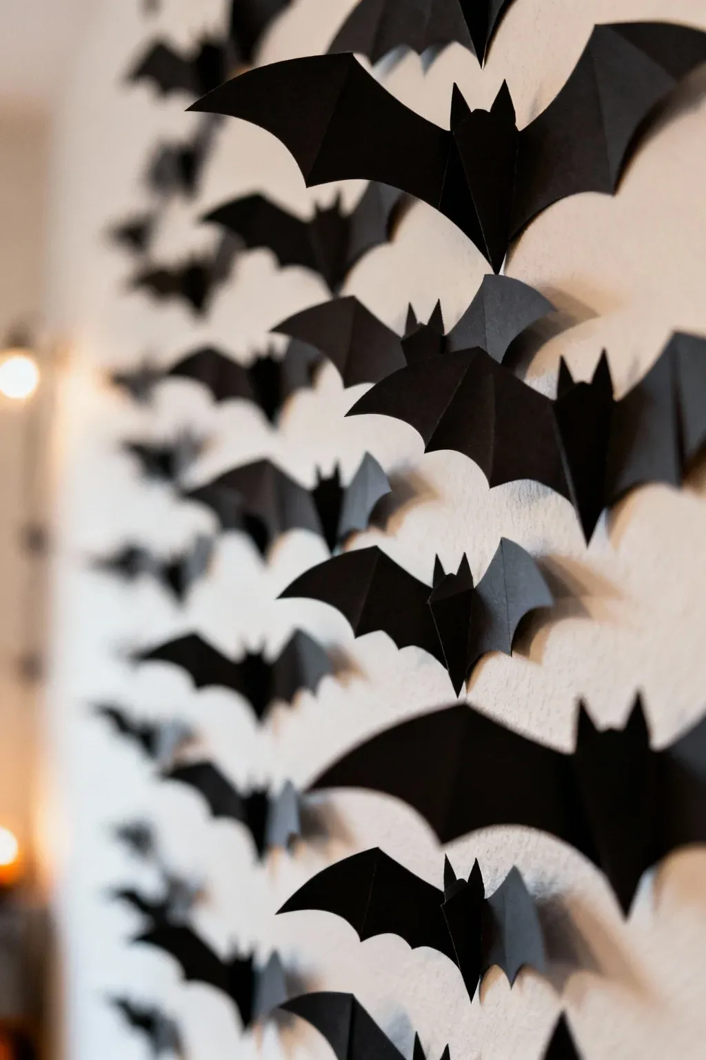 Crescent moon wall decor with bats flying across a bedroom wall
