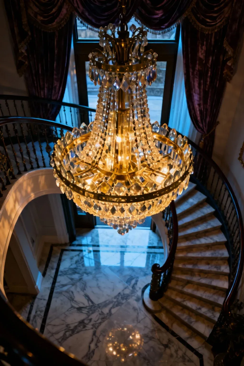 Grand artistic chandelier illuminating an elegant entryway.