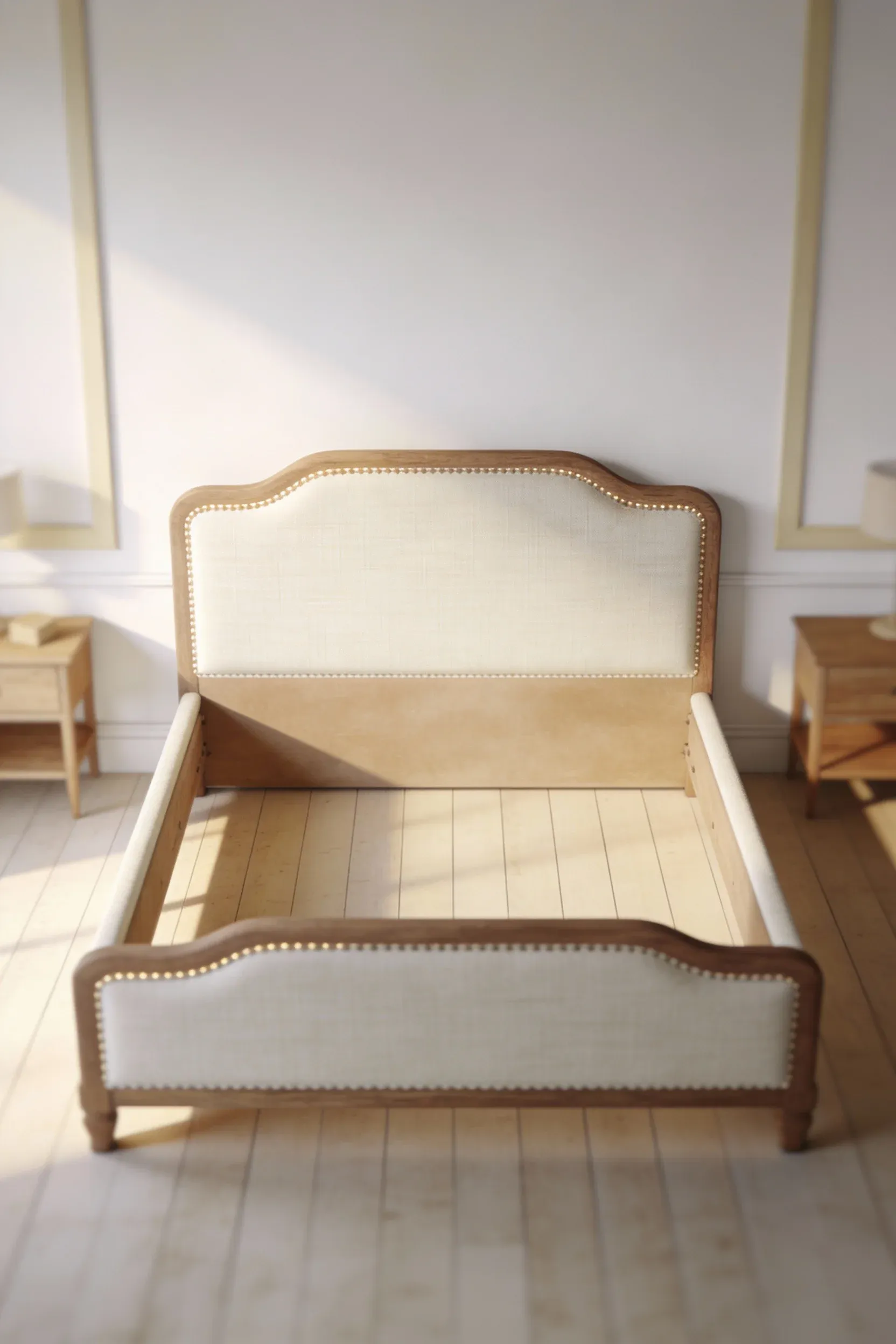Cream and beige upholstered bed frame centered in a soft white and beige bedroom.