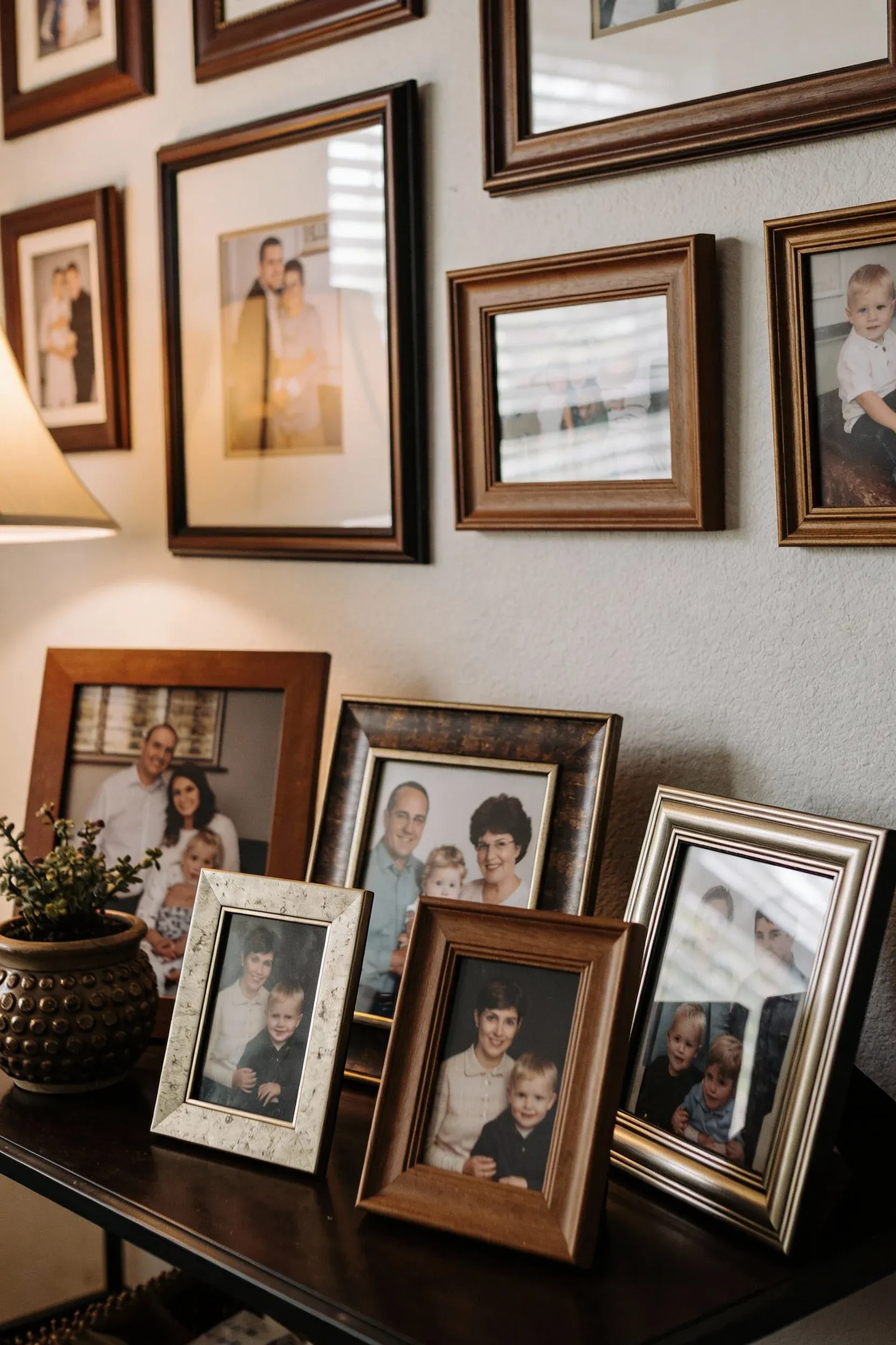 A cluster of framed family photos adding warmth and nostalgia to a living room.