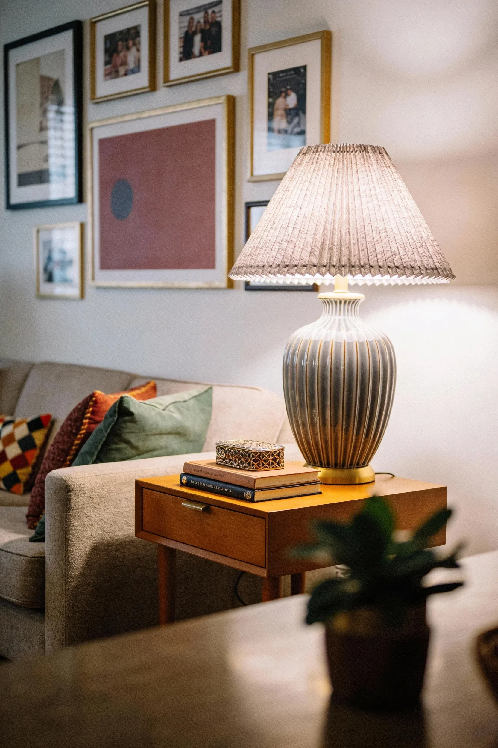 A cozy living room corner with a textured pleated lampshade providing soft lighting.