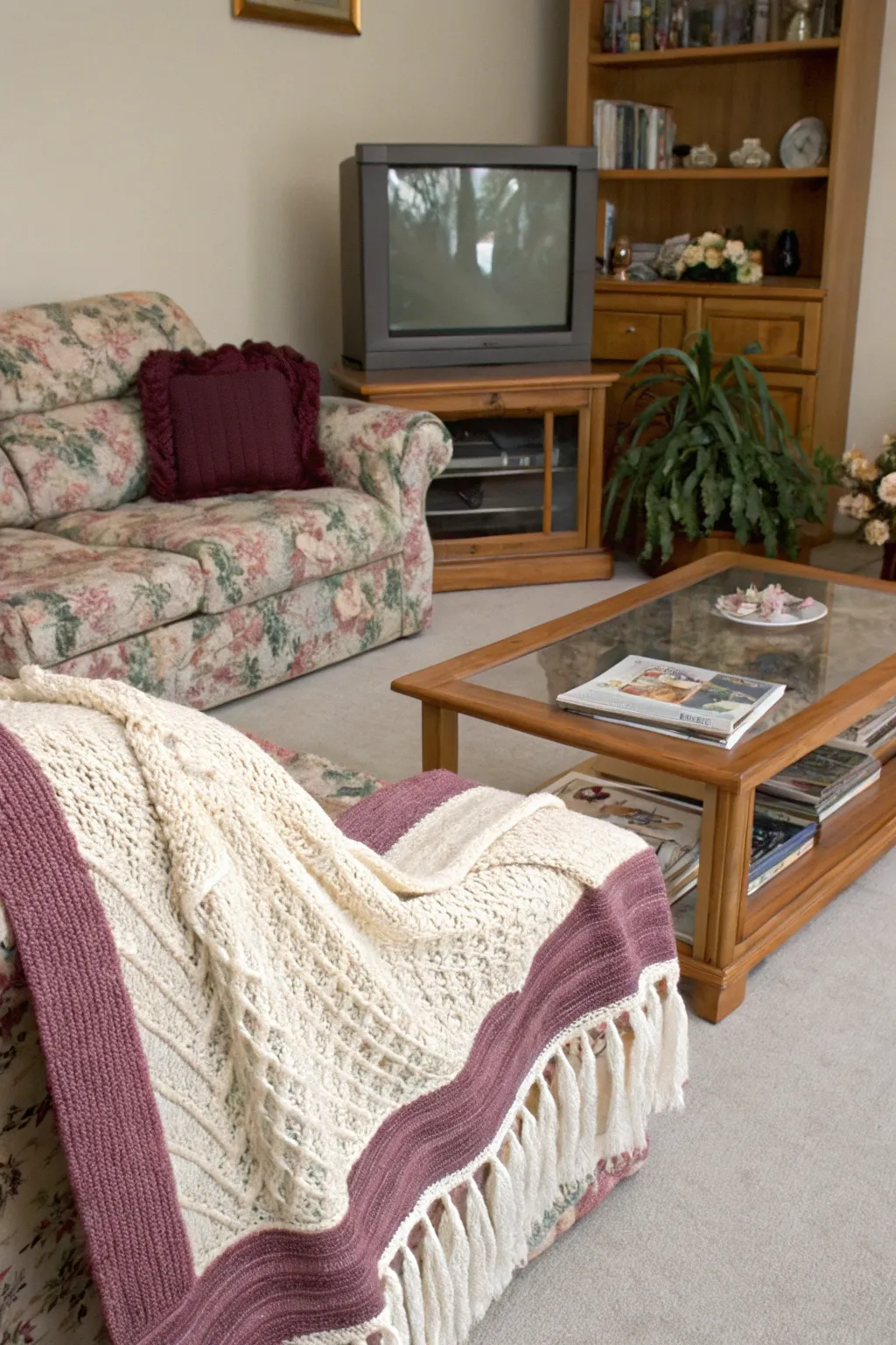 A cozy 1990s living room featuring layered throw blankets in mauve and cream.