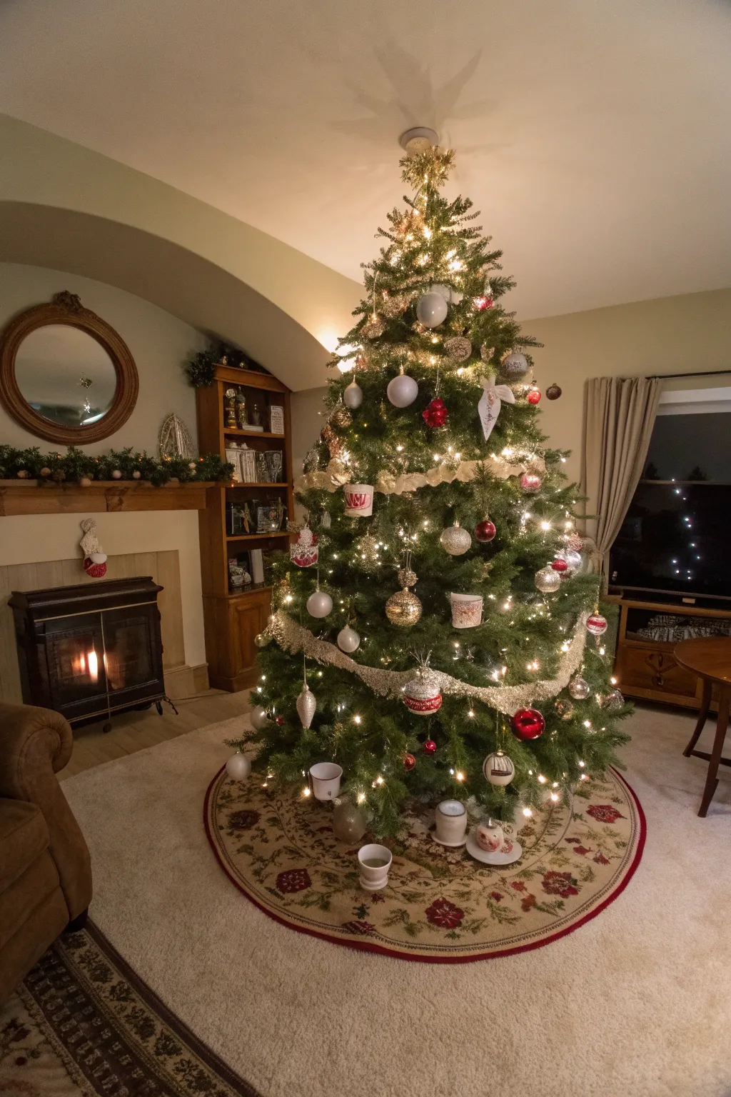 A Christmas tree decorated with vintage tea cups filled with snow and pinecones.