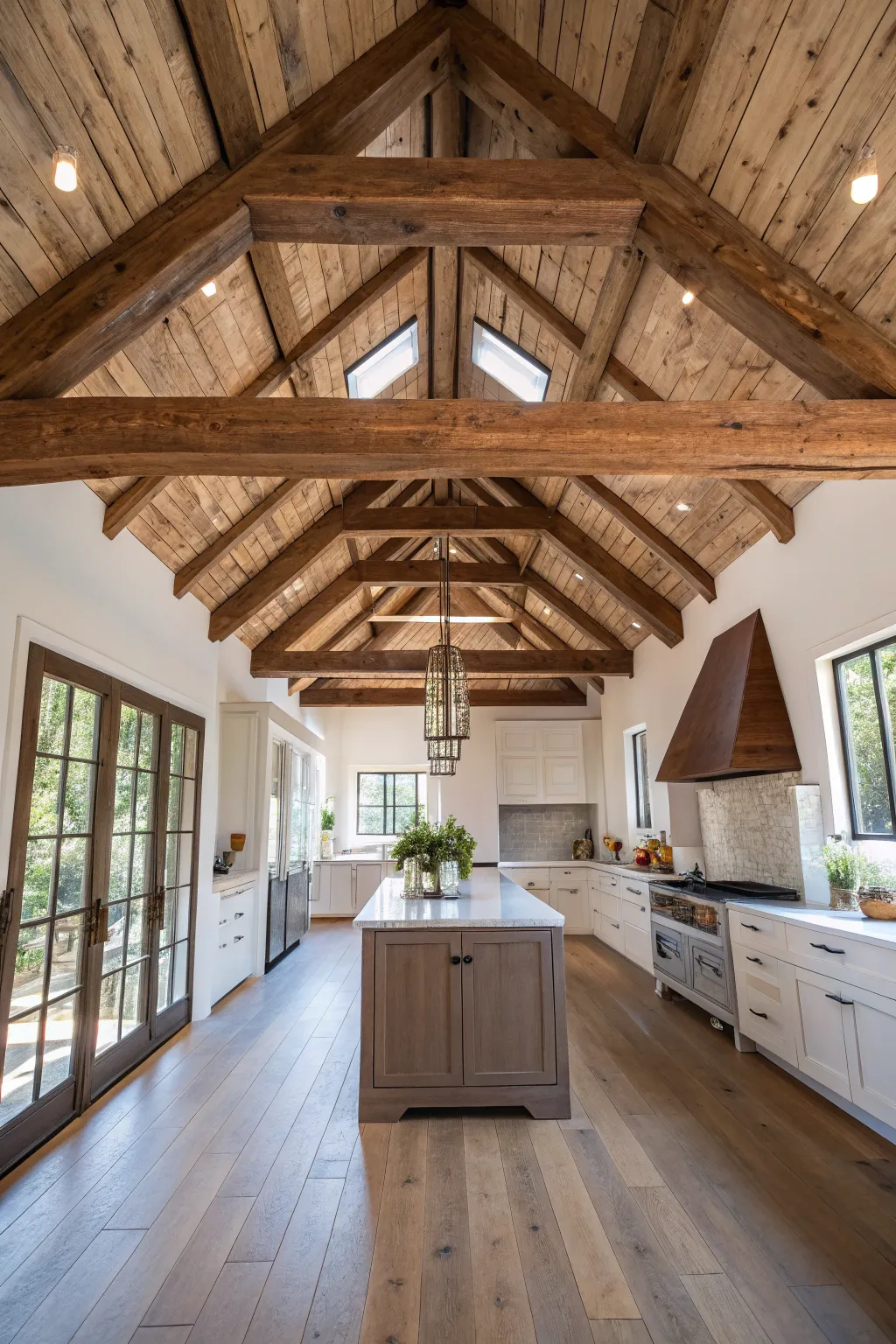 Rustic reclaimed wood beams span across the high white ceiling of a modern Scandi-Boho kitchen.