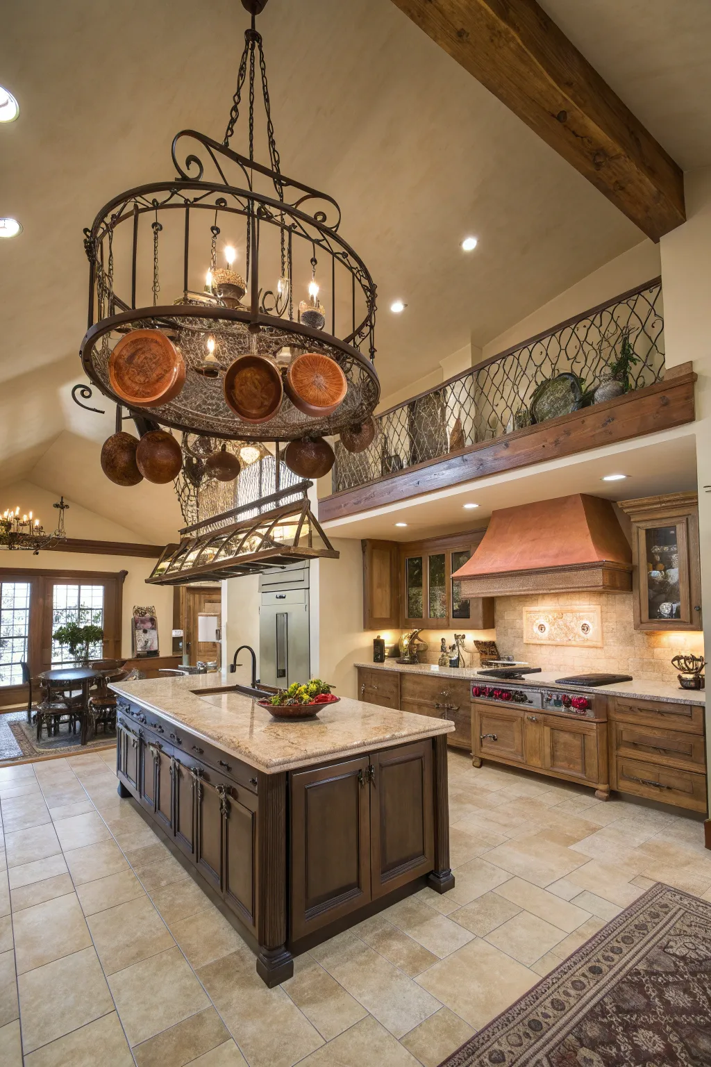 A black wrought iron pot rack hanging over a kitchen island with copper pots and dried herbs.