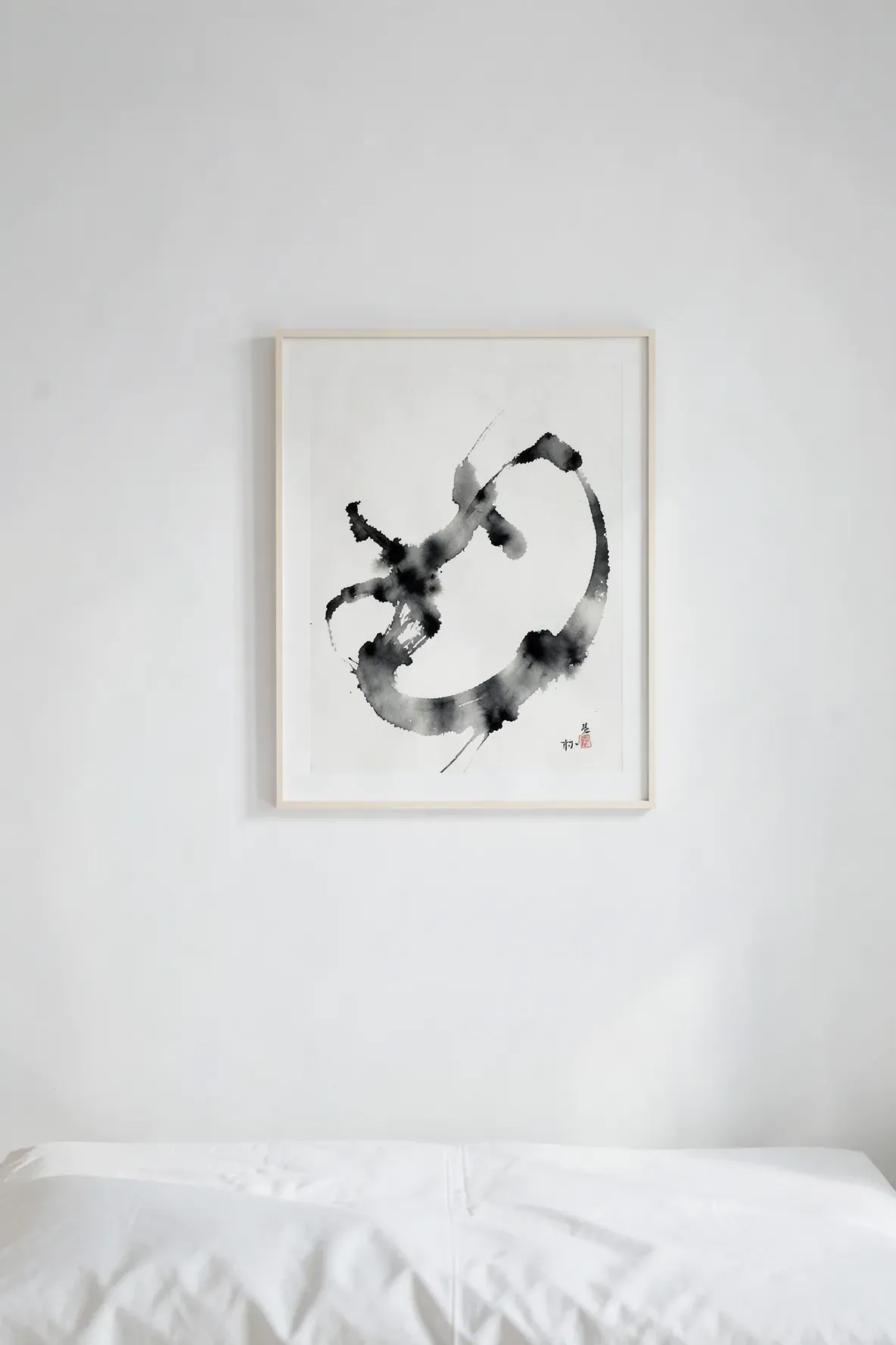 A minimalist black ink wash painting on a white wall in a clean, modern Zen bedroom.