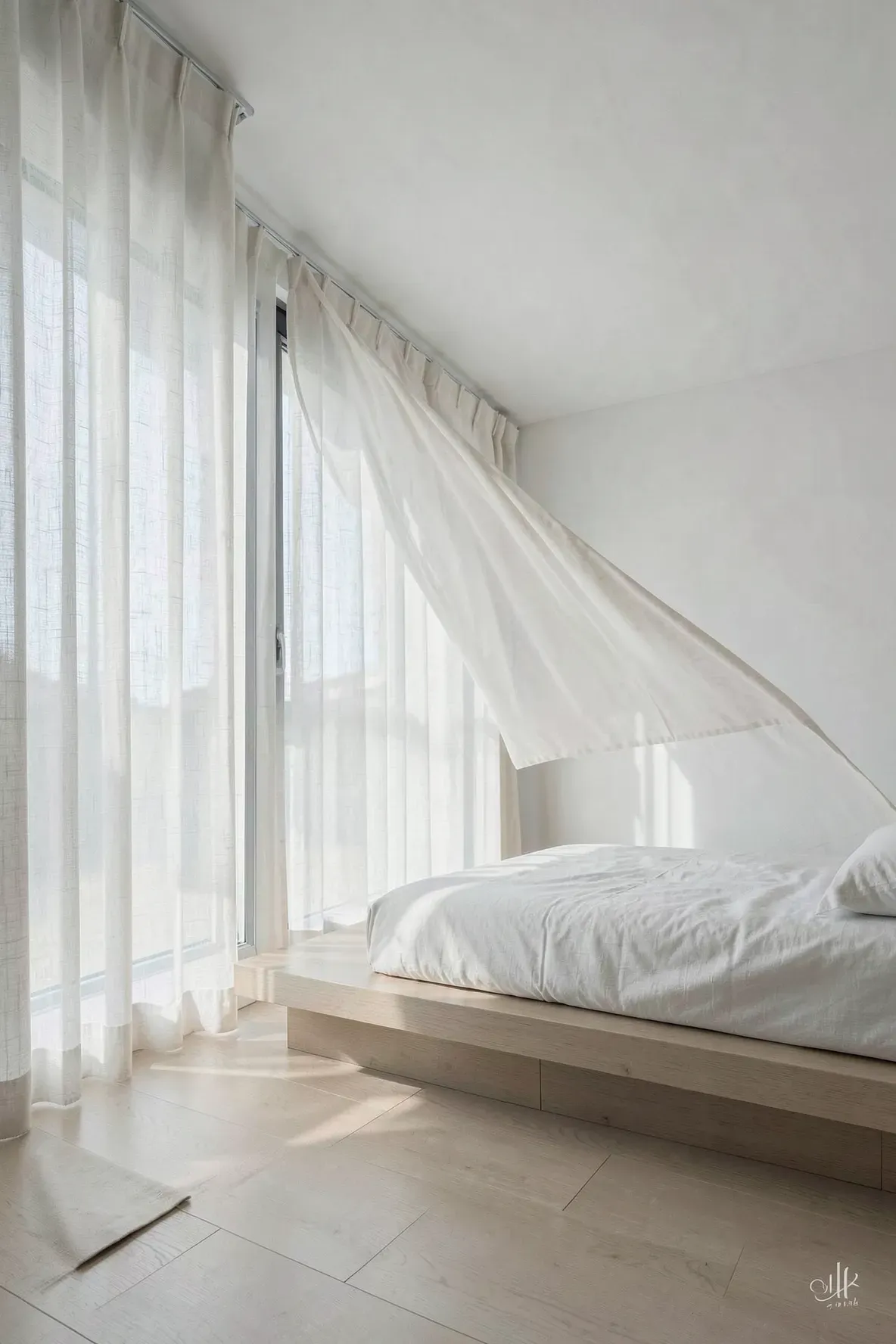 A serene modern bedroom with sheer white linen curtains diffusing soft sunlight over a platform bed.