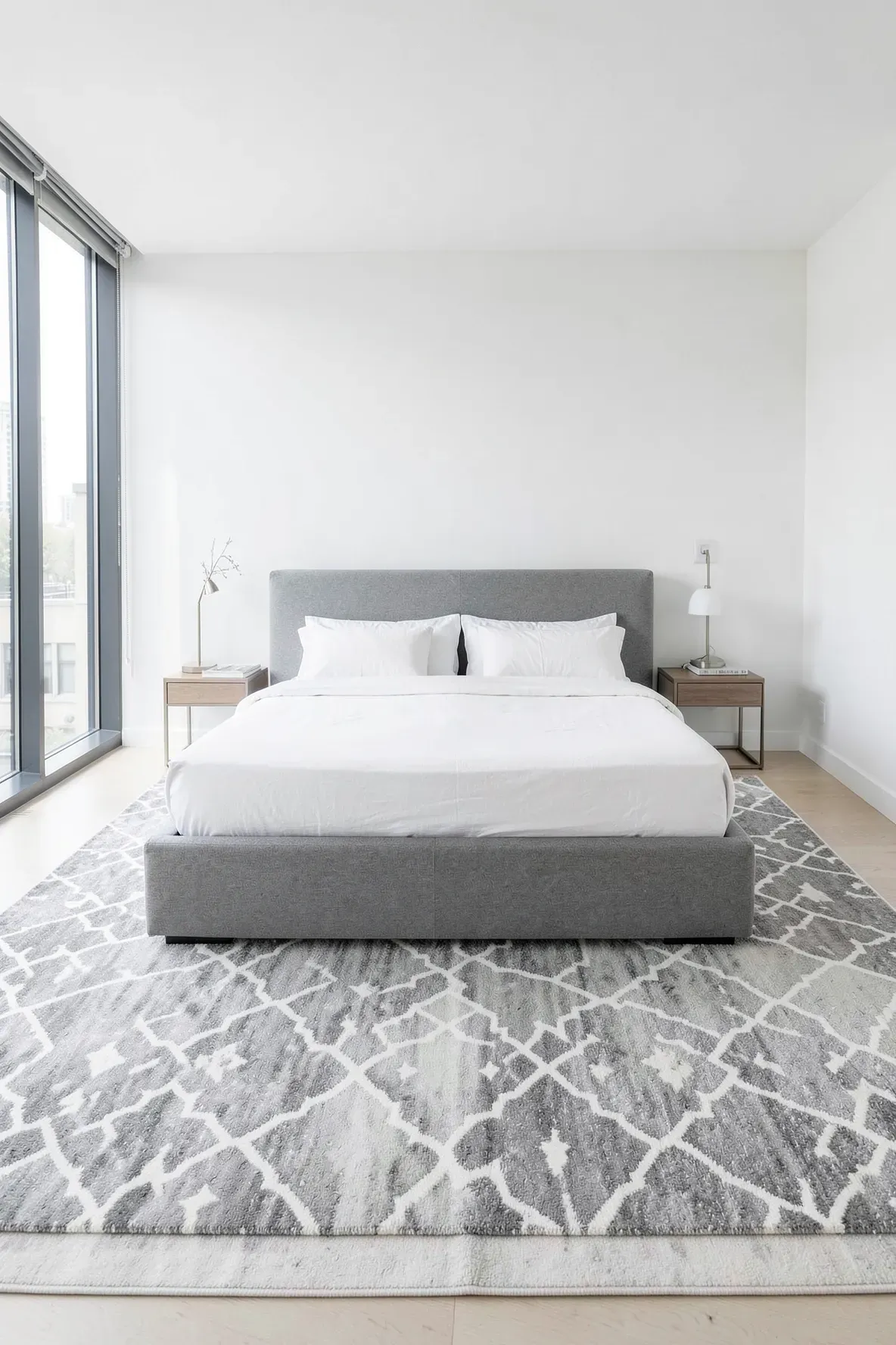 A gray and white Moroccan trellis pattern rug in a bright, modern bedroom.