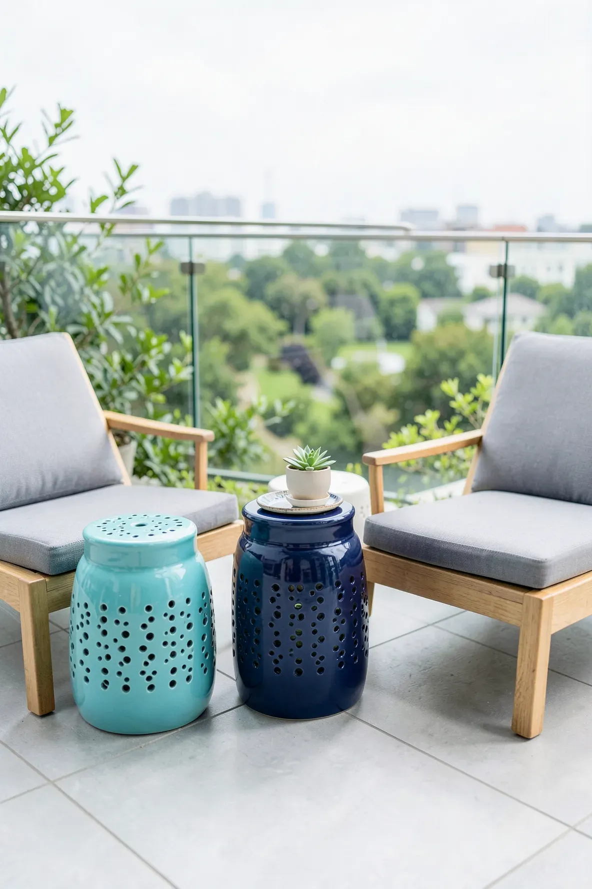 Glossy turquoise and navy ceramic garden stools used as side tables on a modern patio.