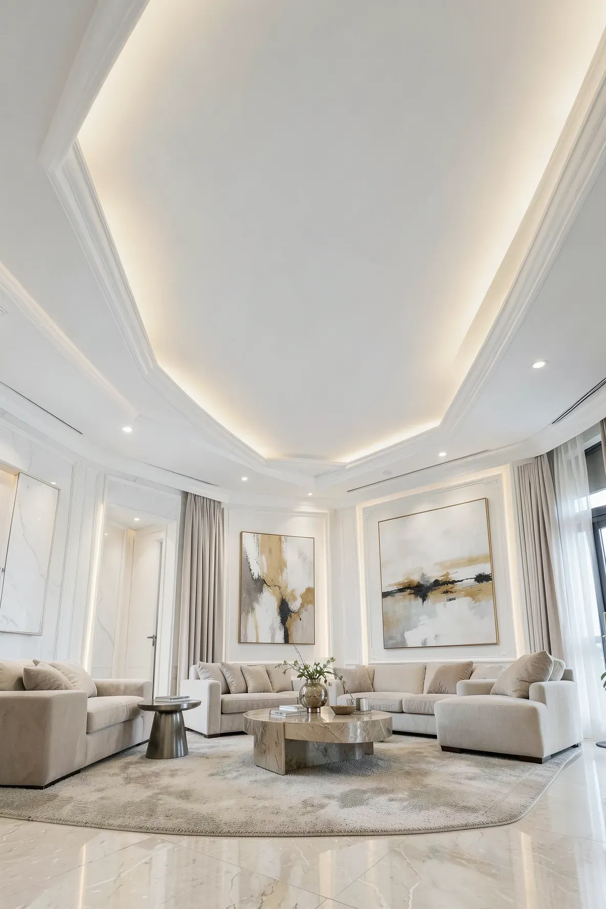 A modern living room with soft, indirect light glowing from a hidden LED strip in the cove ceiling.