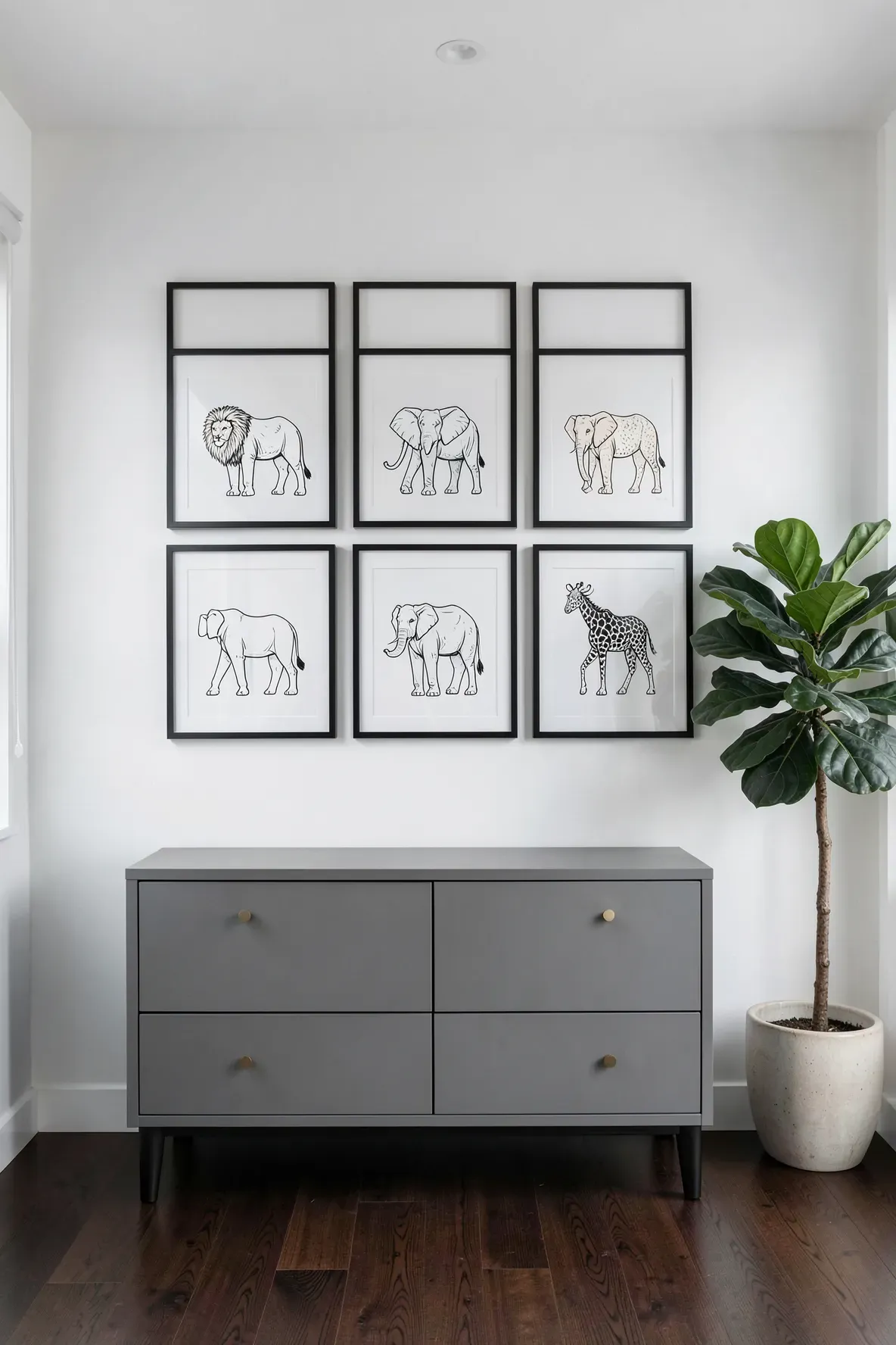 A grid of six black and white minimalist animal line art frames on a white nursery wall.