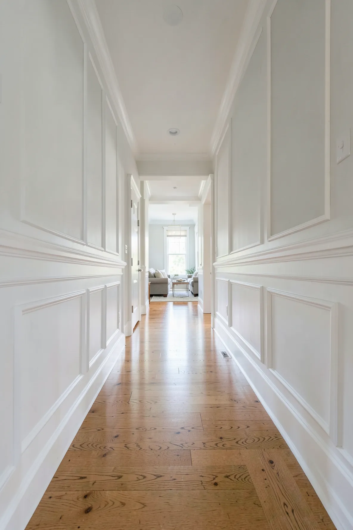 Classic white wainscoting panels on the lower half of a sophisticated entryway wall.
