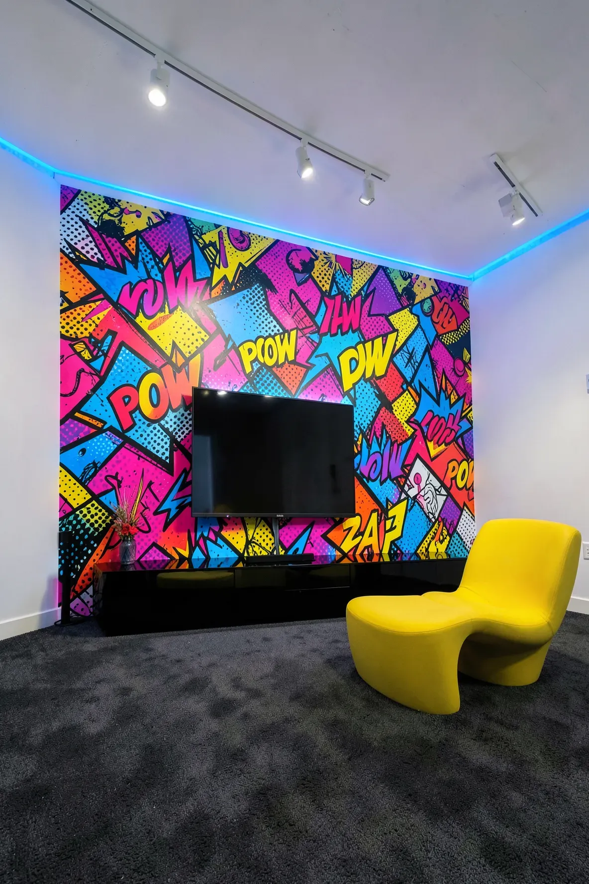 A vibrant media room featuring a bold neon pop art accent wall with comic book style graphics.