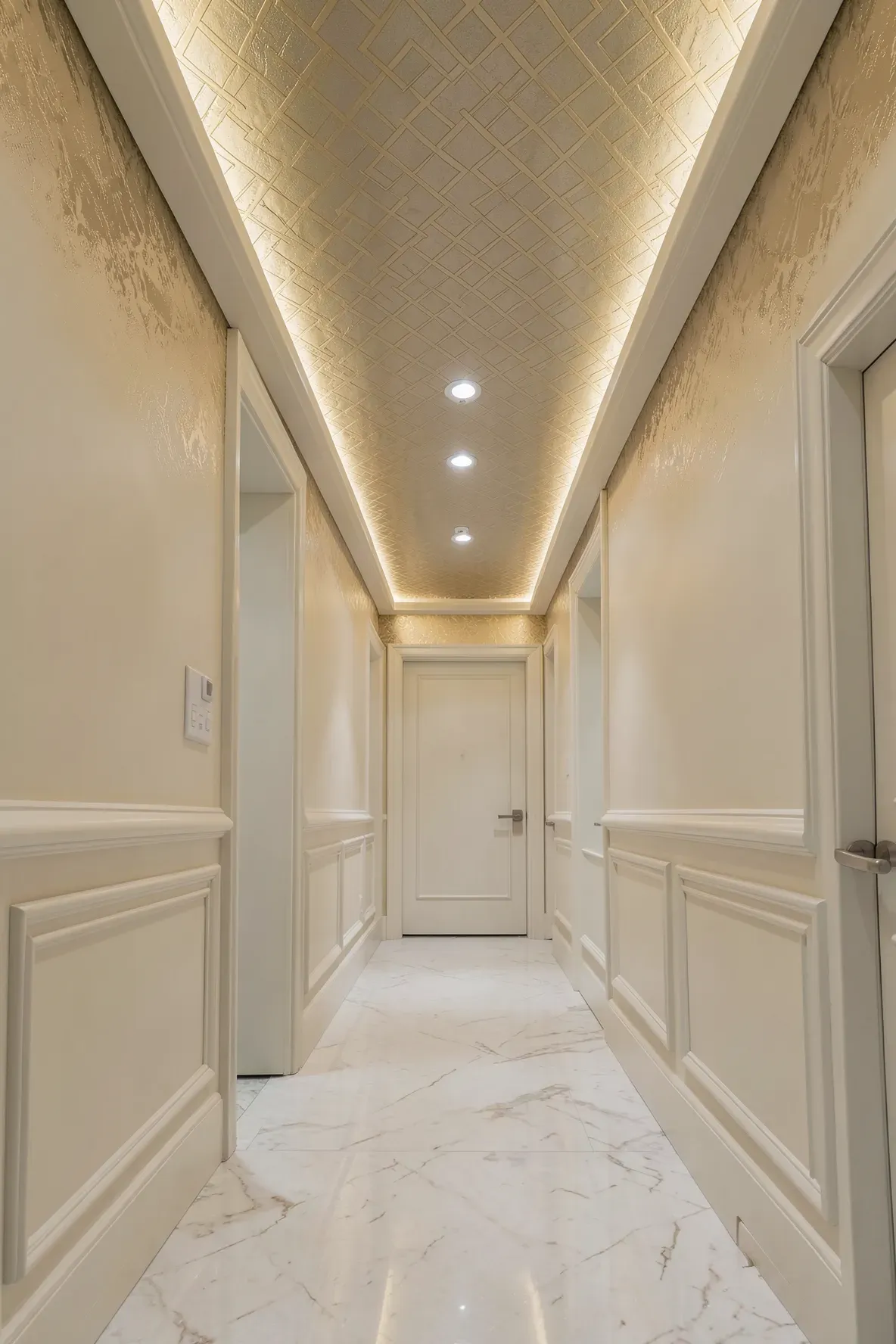 A hallway with elegant geometric wallpaper on the ceiling to make the space feel taller.