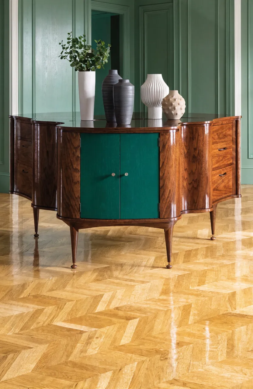 A dark walnut mid-century sideboard with green doors in a stylishly decorated living room.