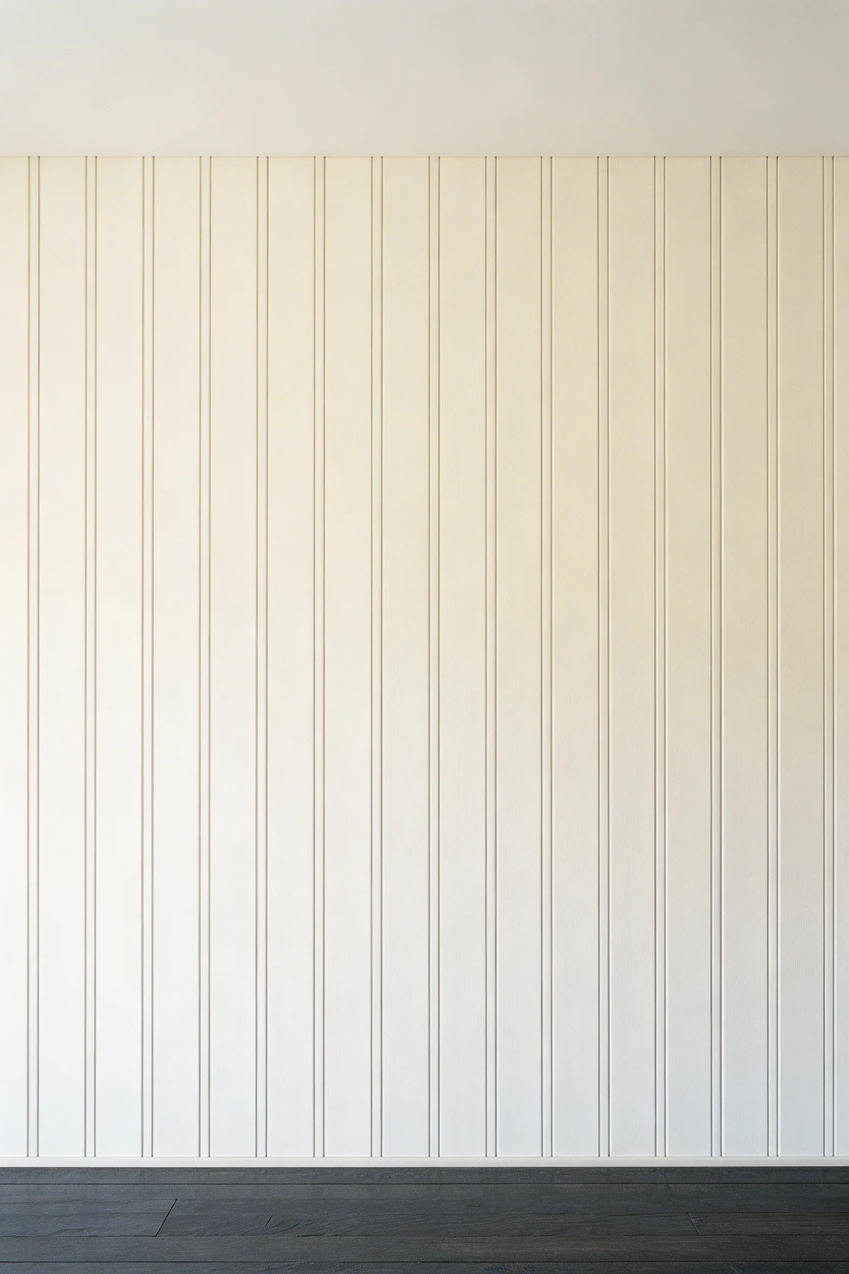 White vertical shiplap paneling on the walls of a narrow hallway, making the ceiling appear higher.