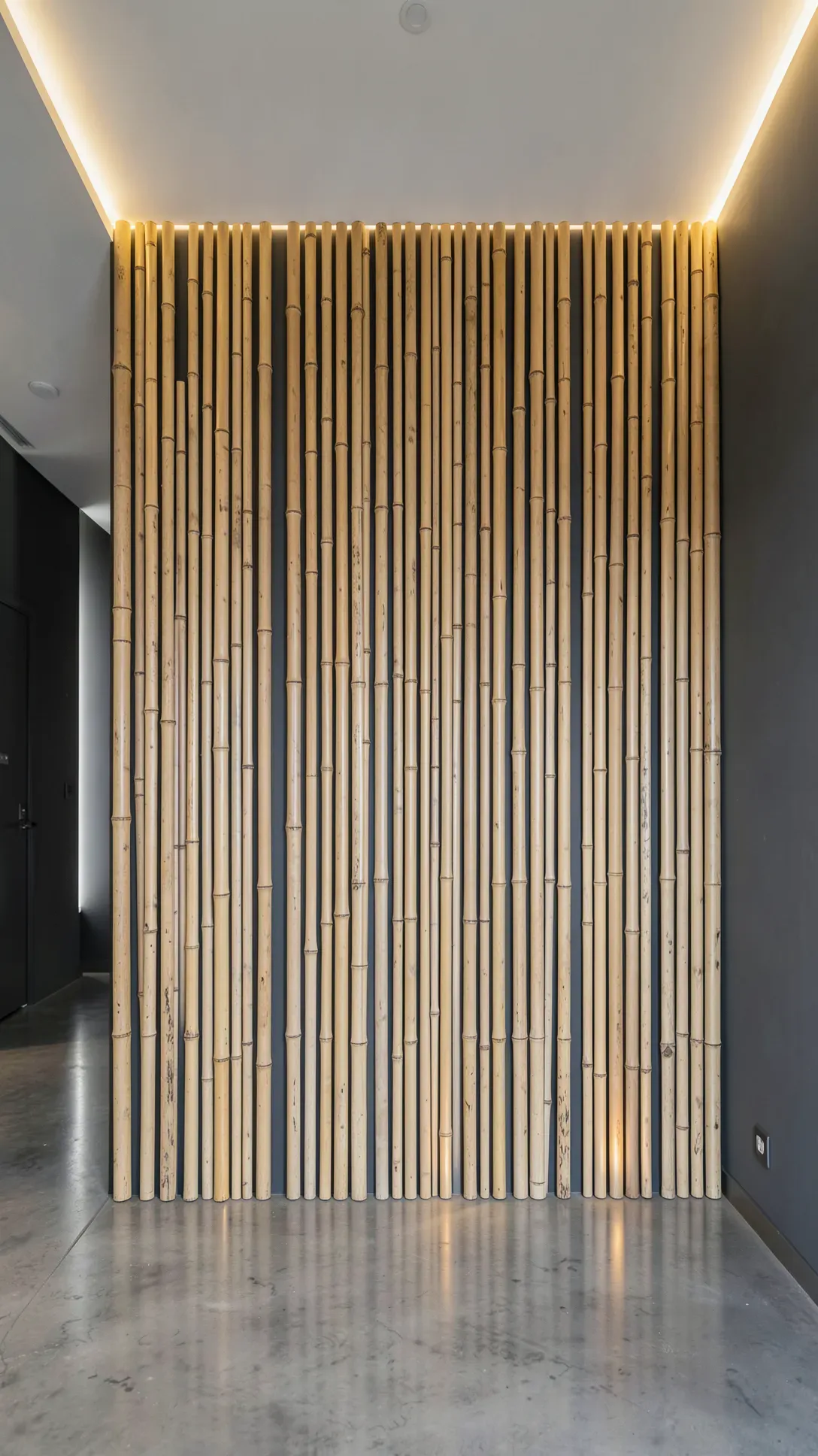 Vertical bamboo poles of different sizes mounted on a dark wall with warm backlight.
