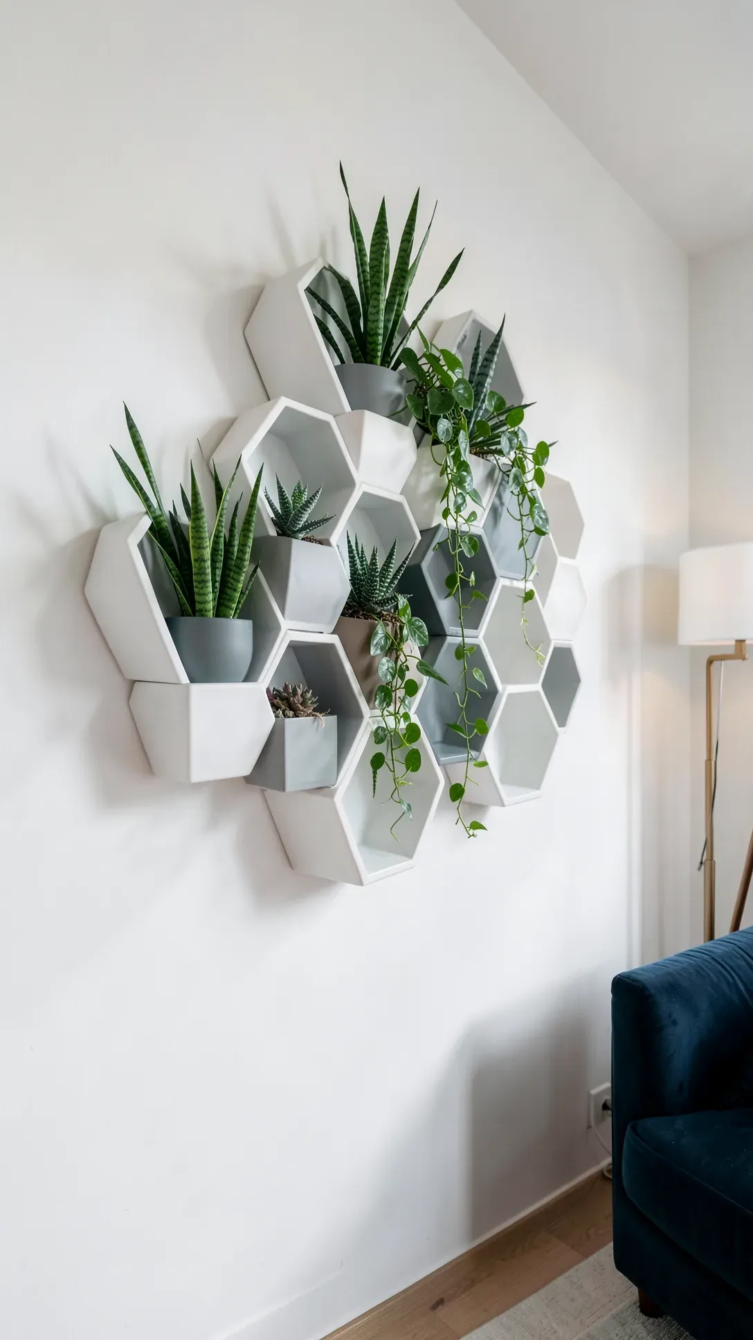 White and grey hexagonal planters arranged in a honeycomb pattern on a living room wall.
