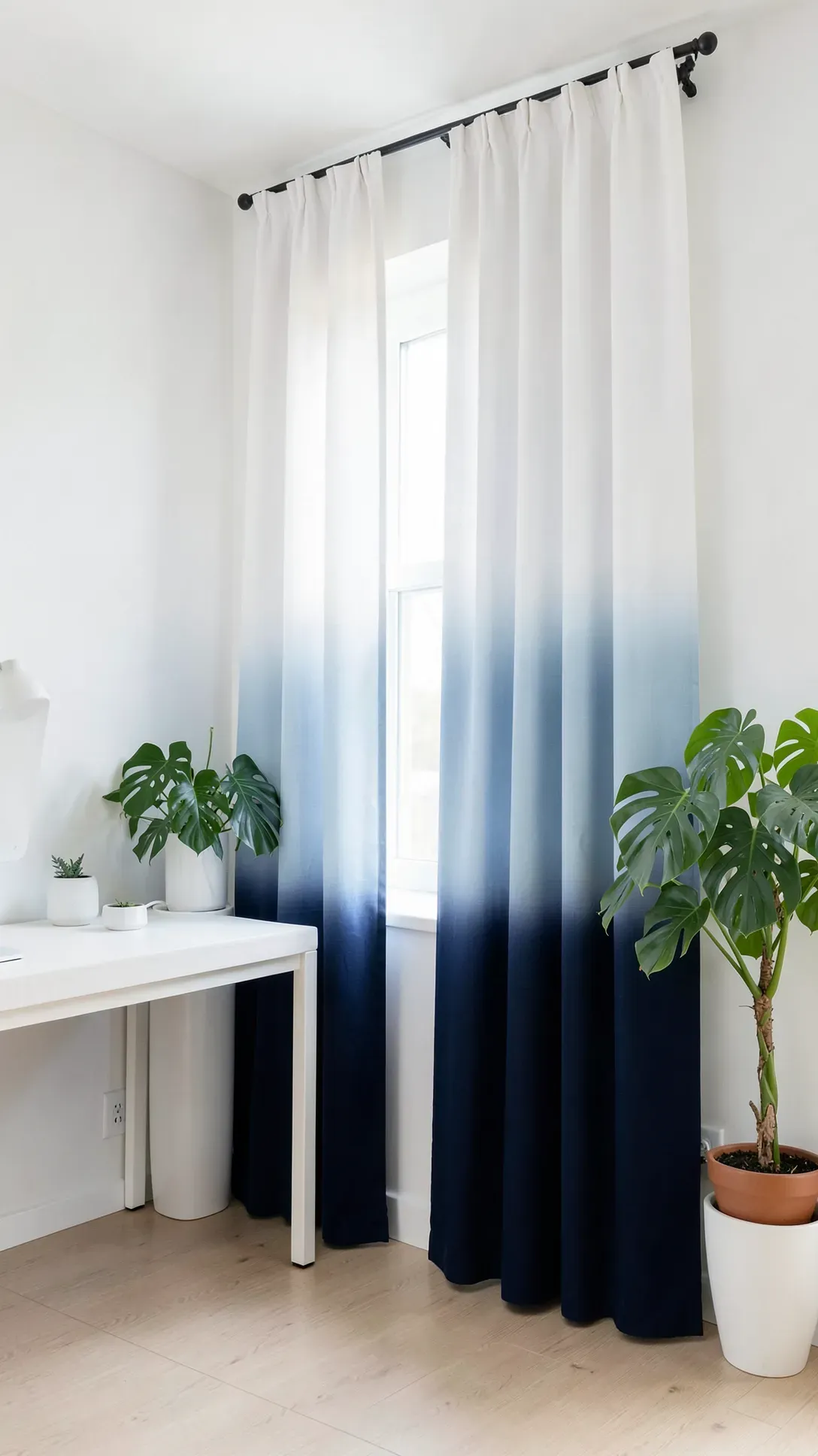 Modern home office featuring curtains that fade from deep navy blue to white.