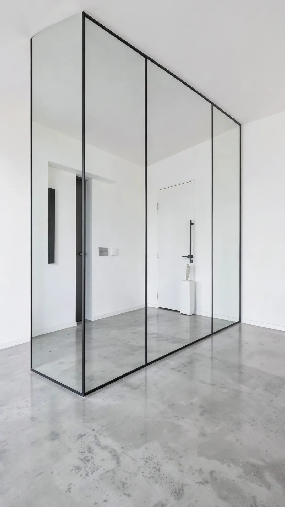 Large floor-to-ceiling mirror panels on a foyer wall, reflecting a modern interior.