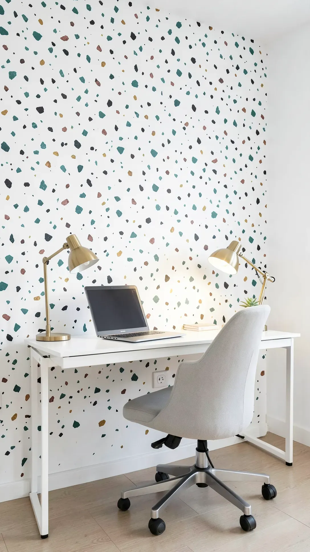 A home office wall decorated with colorful, irregular paint flecks in a terrazzo style.