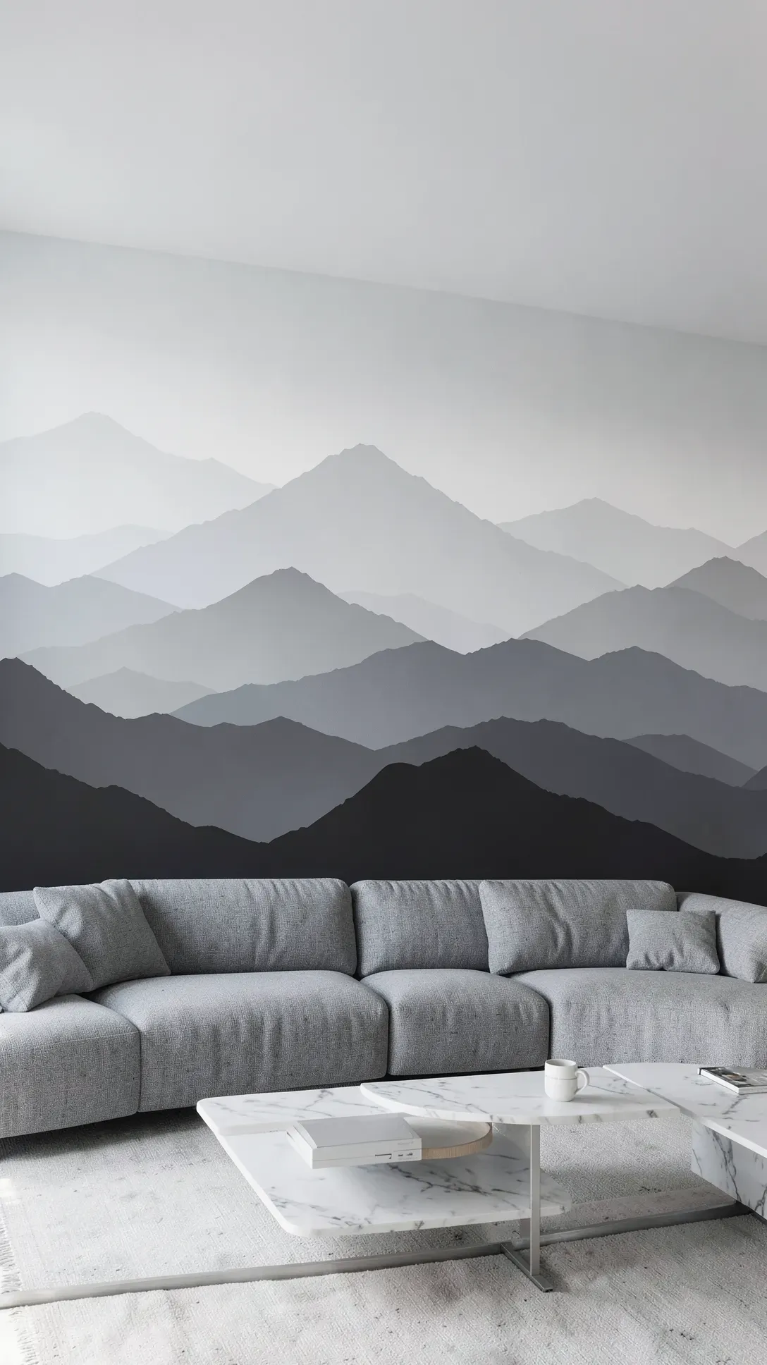 A serene living room with a grey monochrome mountain silhouette mural creating a sense of depth.