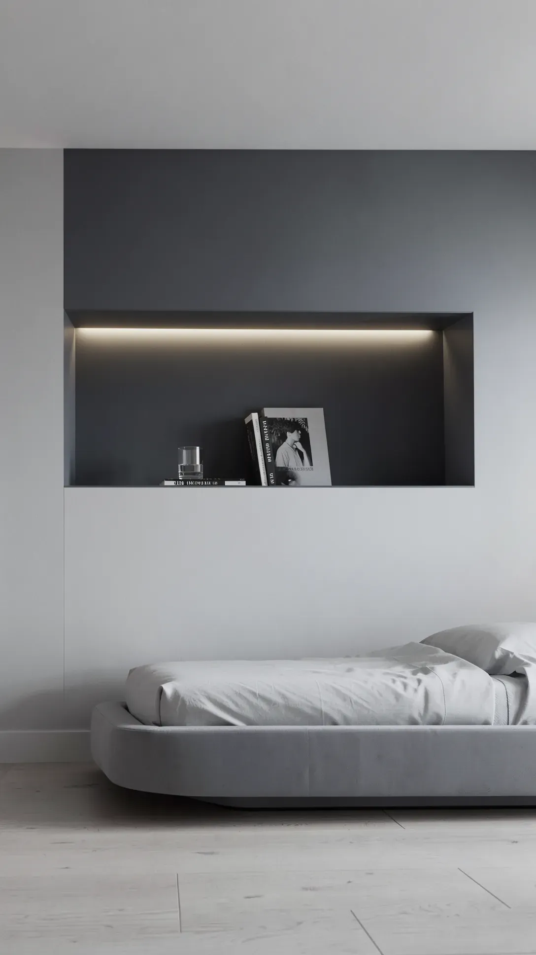 A minimalist bedroom wall with a recessed niche and soft LED lighting above the bed.