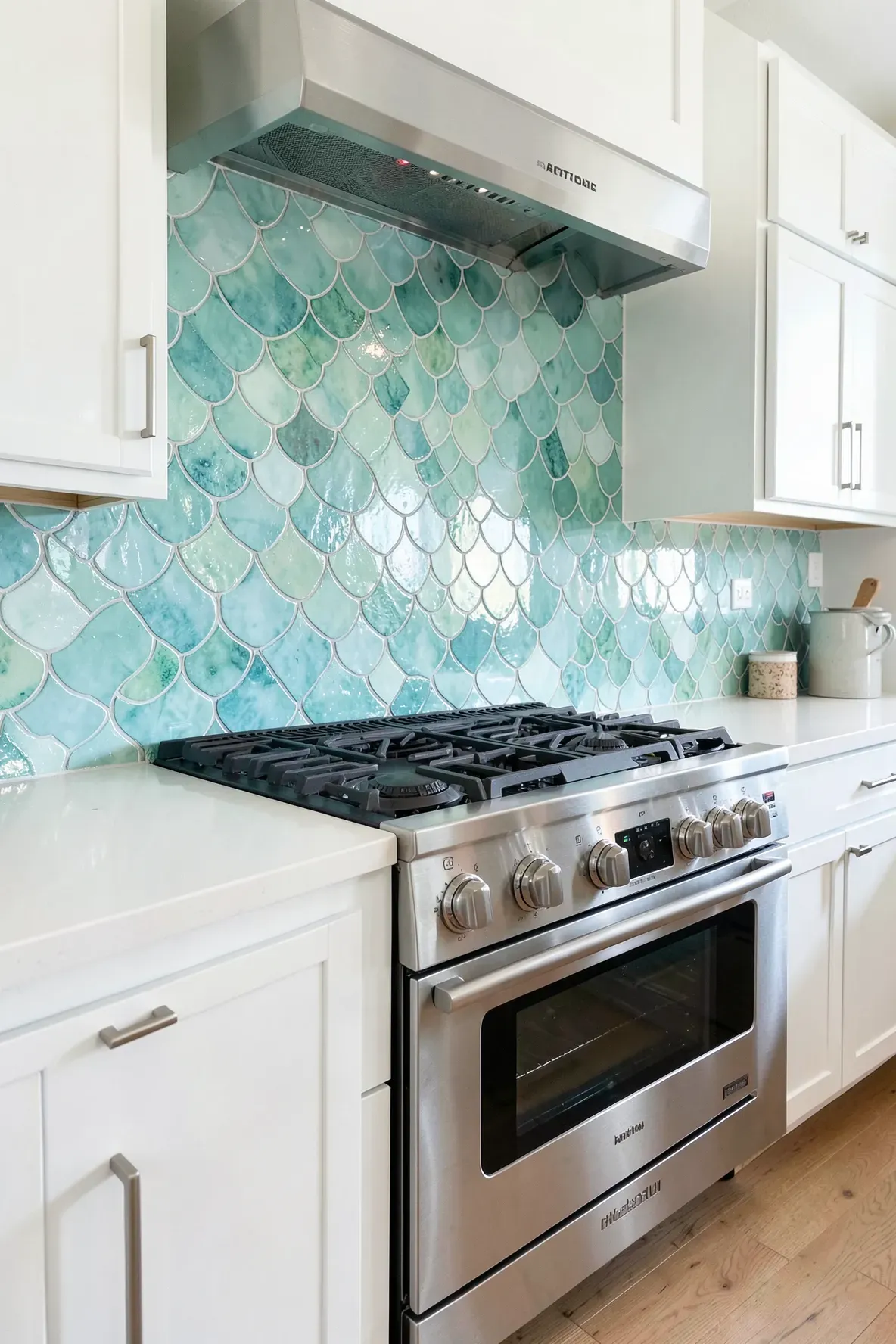 Hand-painted turquoise fish scale backsplash tiles in a bright coastal kitchen.