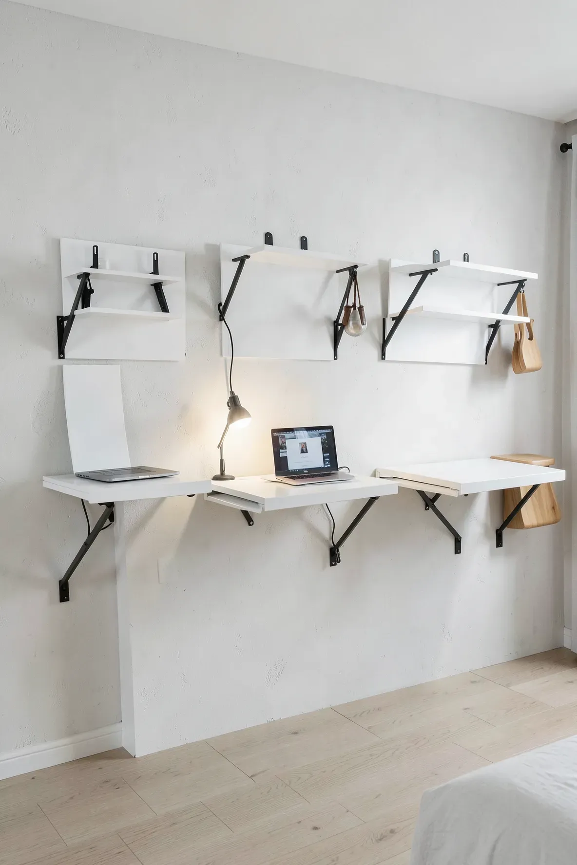 Three space-saving folding desks mounted on a bedroom wall for a shared study space.