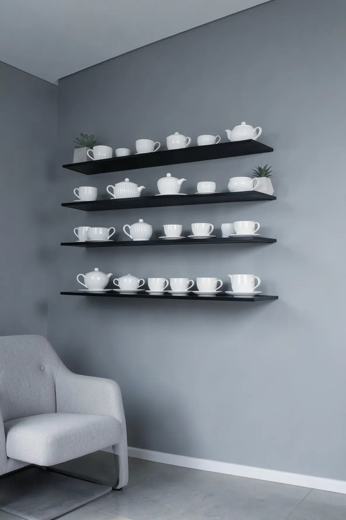 Minimalist black floating shelves holding a collection of all-white vintage teacups.