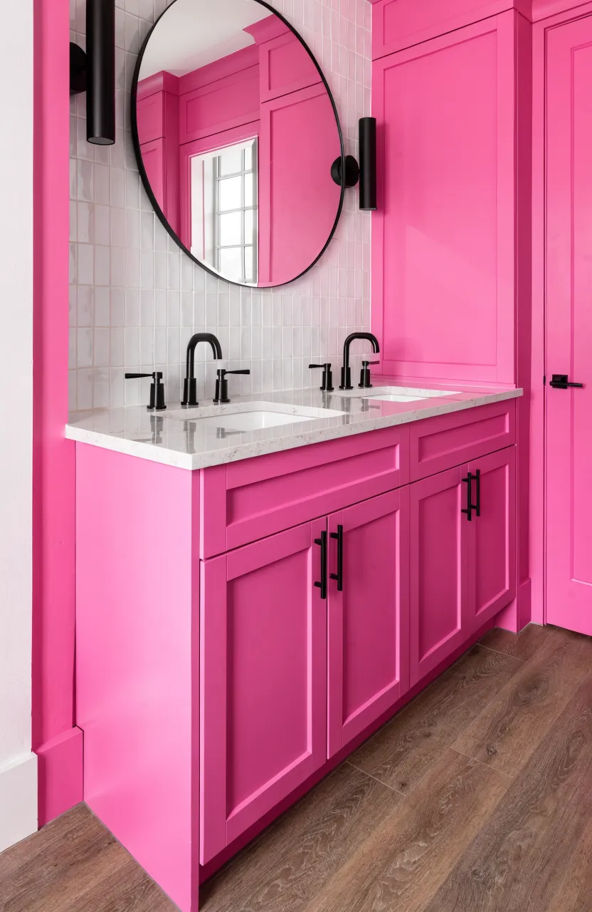 Modern hot pink bathroom cabinets with minimalist black handles and a white quartz countertop.