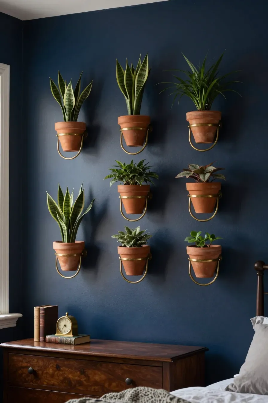 A grid of aged brass rings holding terracotta pots on a dark navy bedroom wall.