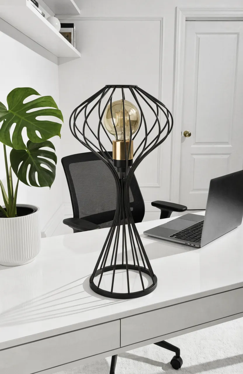 A black geometric wire frame lamp on a white desk in a minimalist, bright home office.