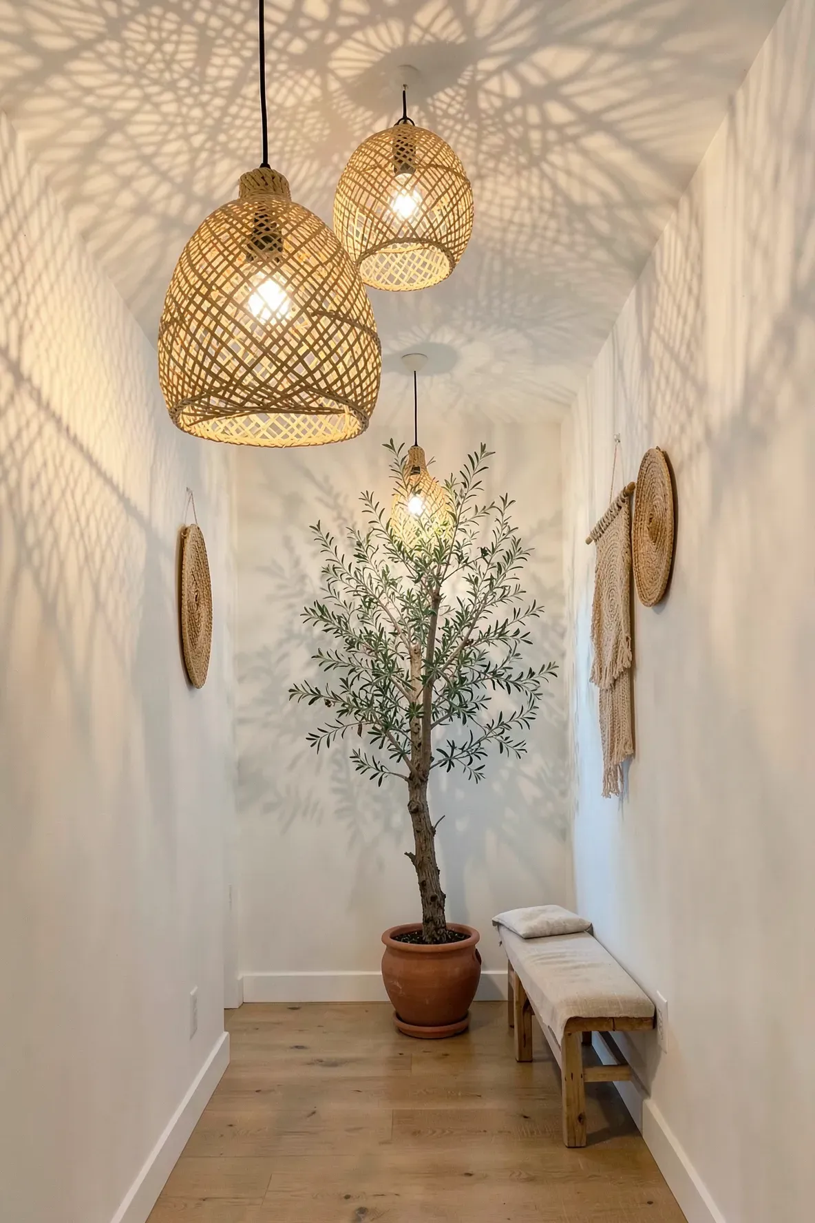 Woven rattan pendant lights casting beautiful patterned shadows in a bright boho hallway.