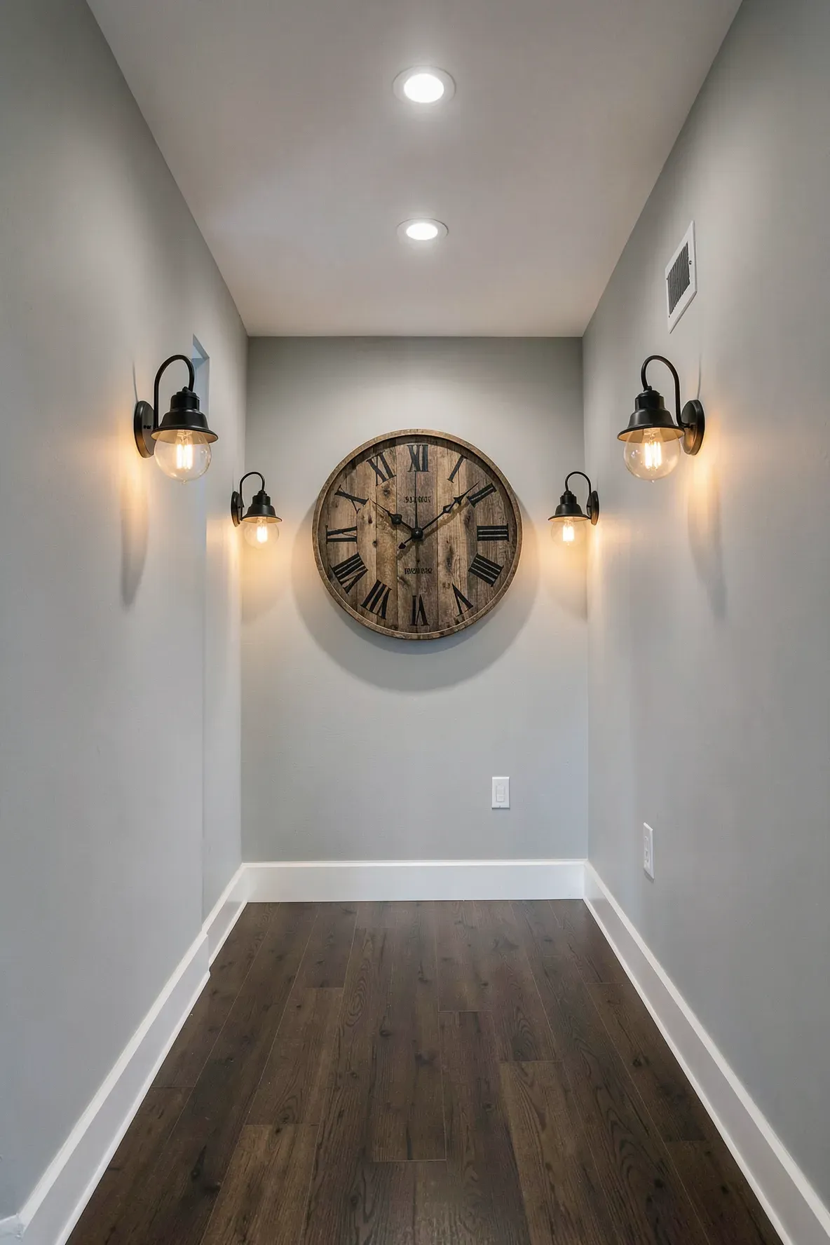 A large round wooden clock centered at the end of a long narrow hallway.