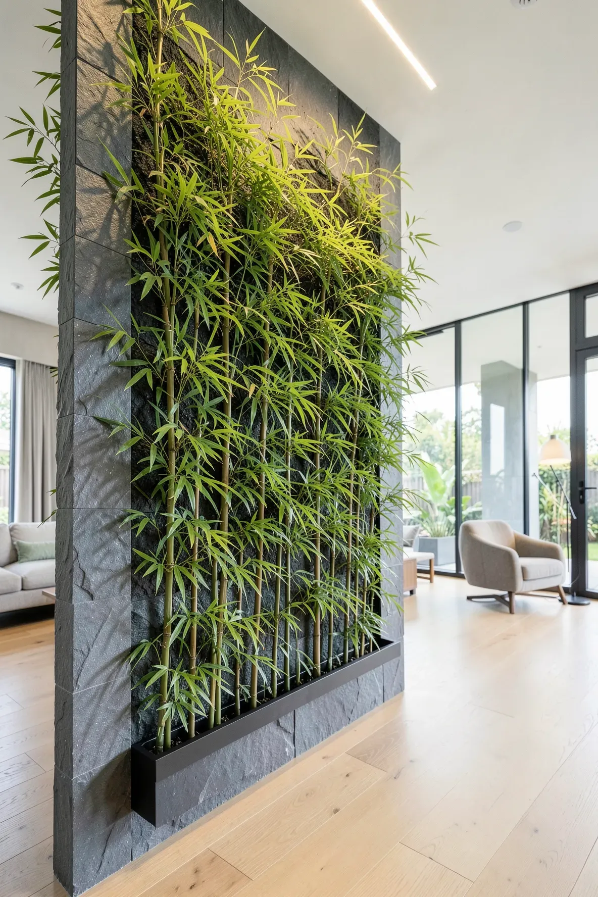 A lush vertical garden of living bamboo plants mounted on a slate stone wall indoors.
