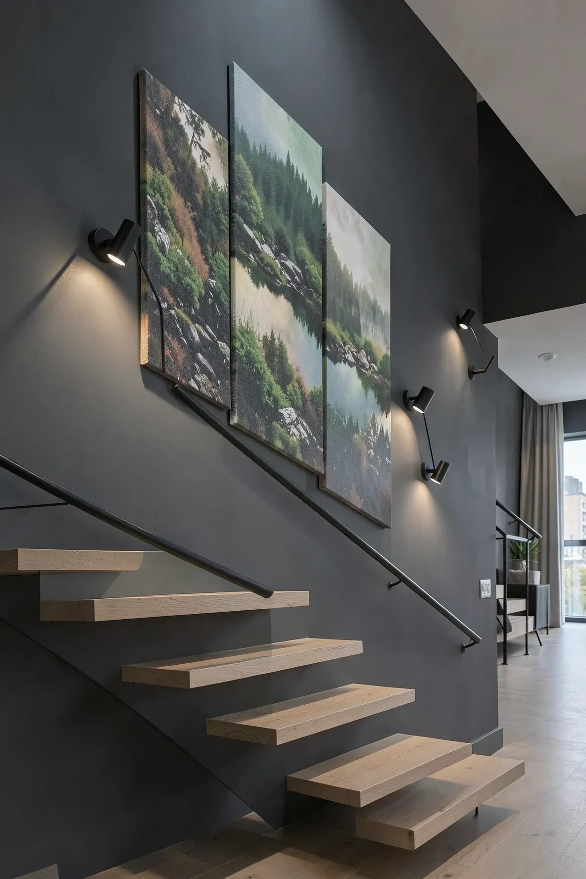 Large abstract canvases on a dark staircase wall with adjustable black swing-arm sconces.