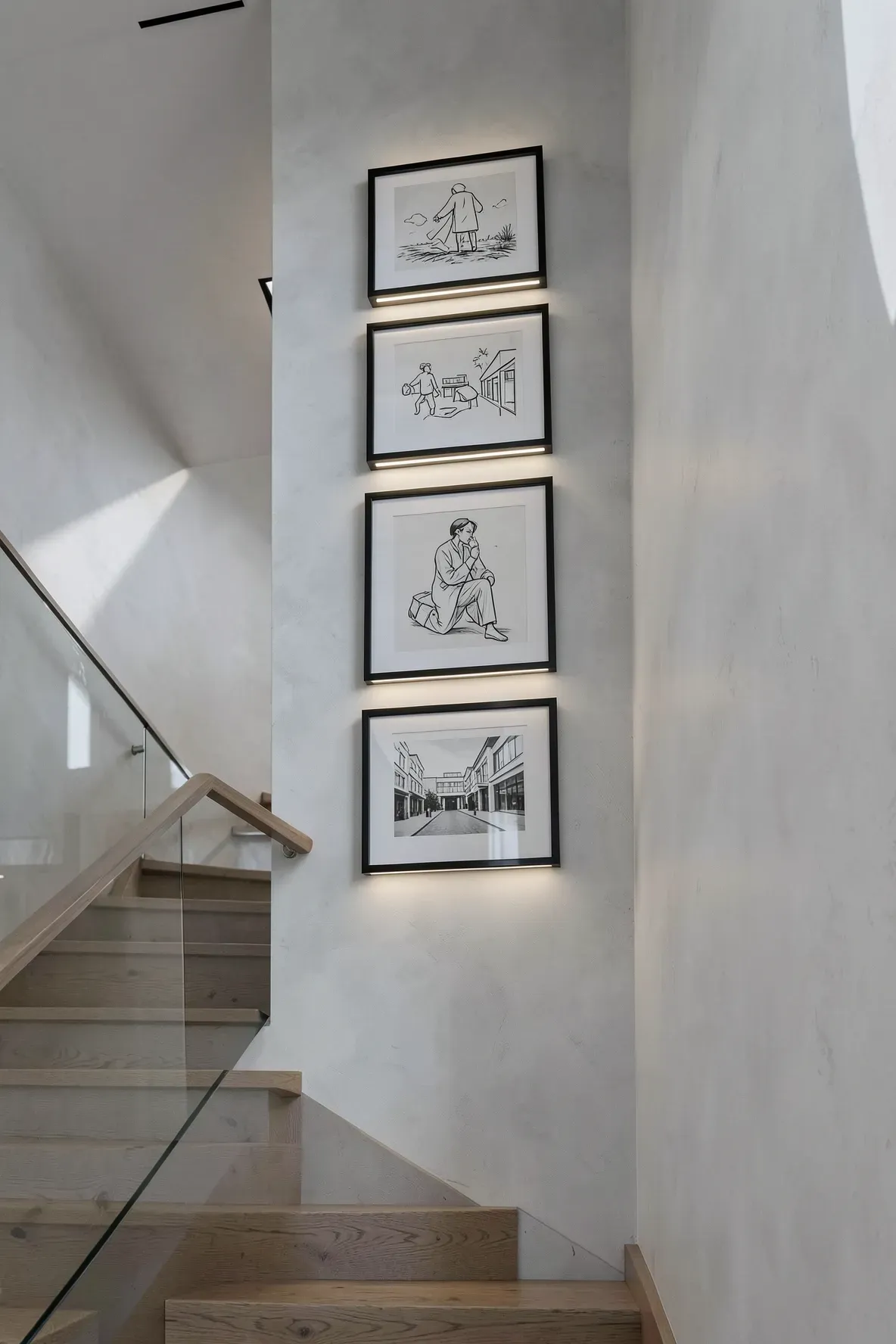 A vertical stack of narrow black frames on a stairwell wall lit by slim LED bars.