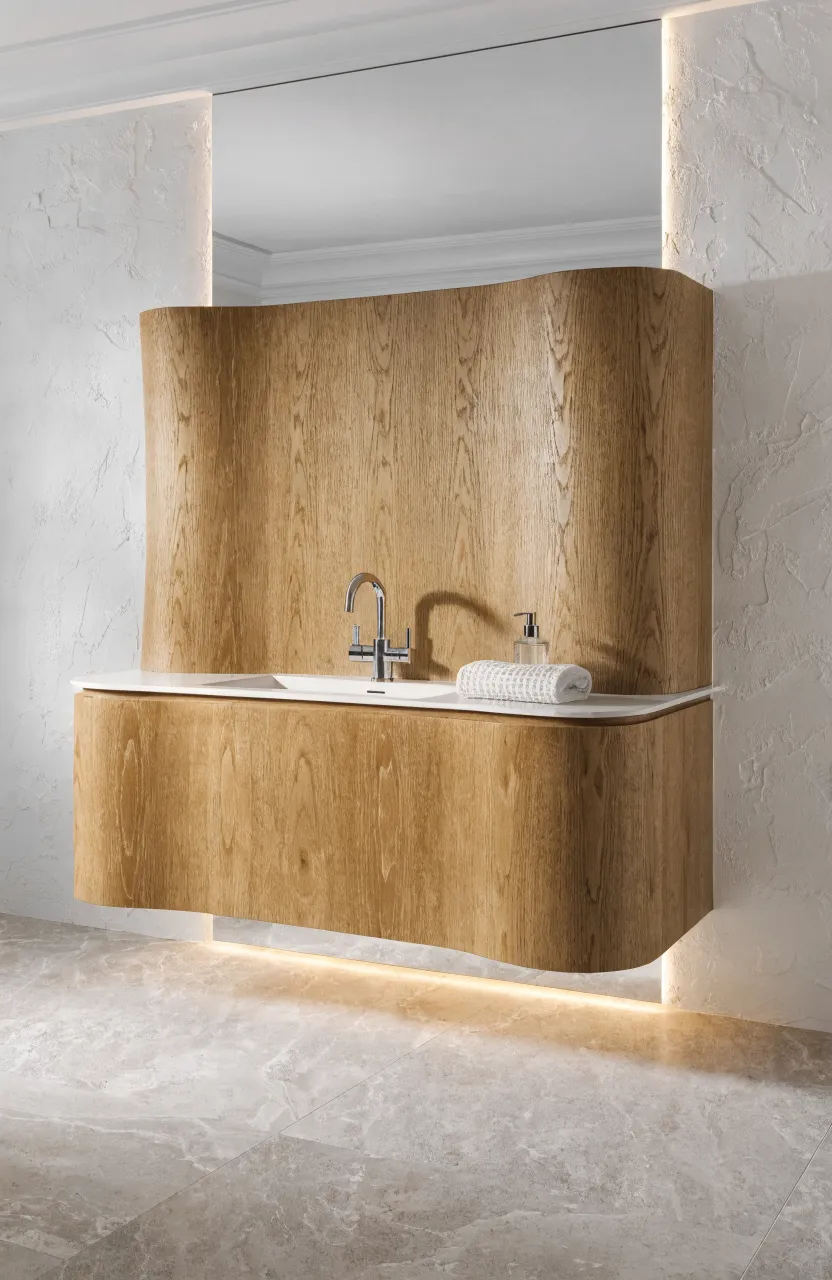A modern floating oak vanity with a soft warm glow of LED lighting underneath in a bright bathroom.