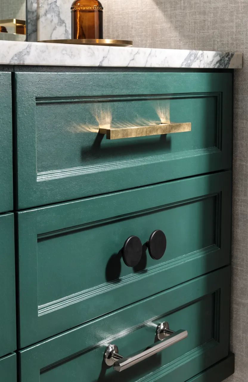 Close-up of a green vanity showing gold, black, and nickel hardware options.