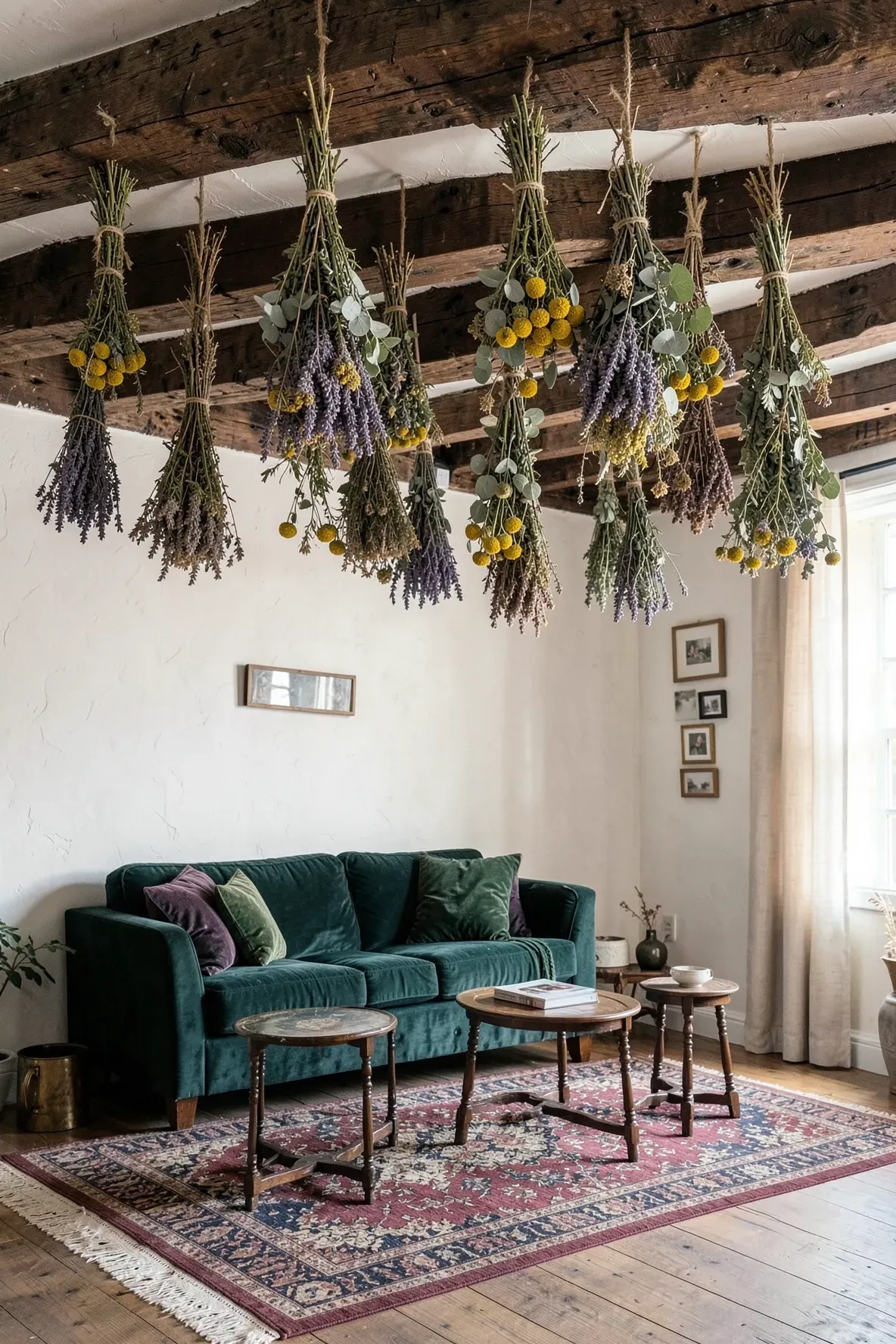 Dried wildflower bundles hanging from rustic wooden ceiling beams in a cozy eclectic living room.