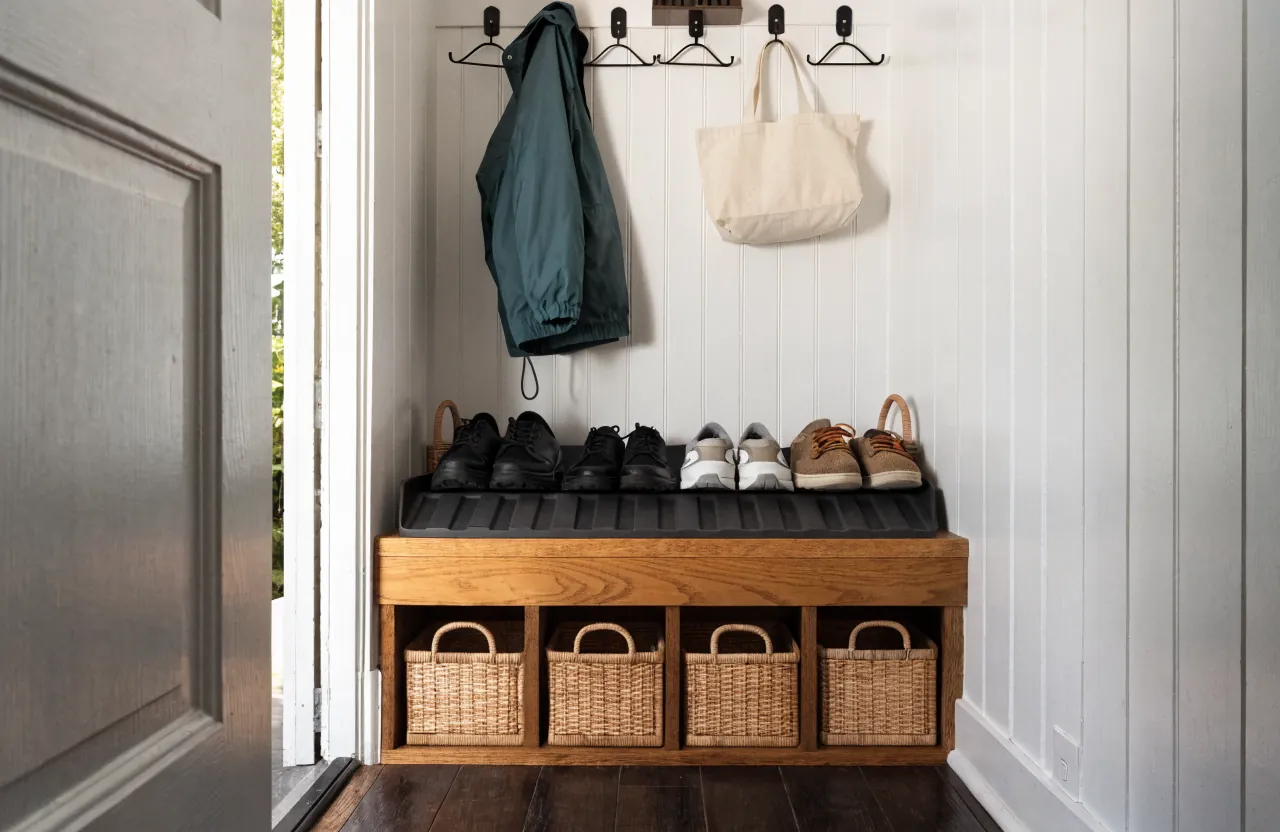 Tiny house entry bench with shoe cubbies hooks and a compact drop zone