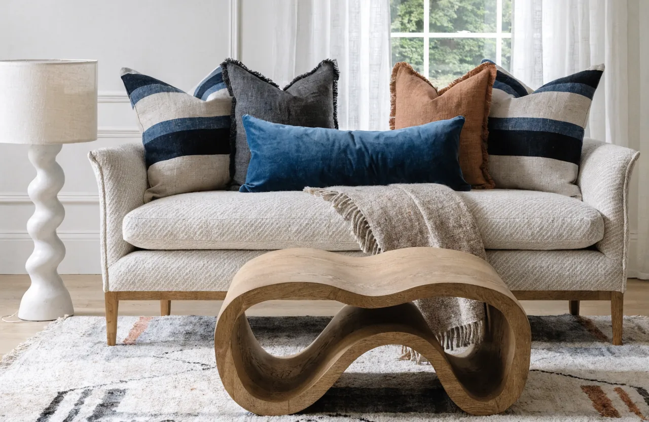 Sofa styling with larger corner pillows, medium accent pillows, and a lumbar pillow