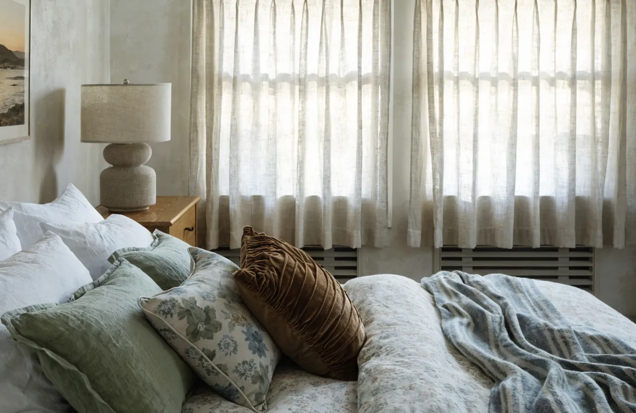 Bed pillows using a muted pattern and color palette for a layered bedroom look